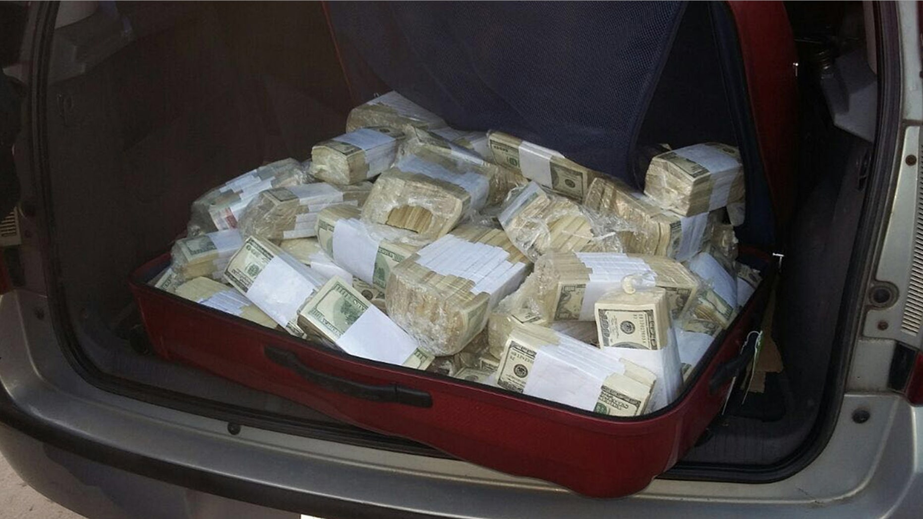 June 14, 2016: In this photo released by the Buenos Aires Province Security Ministry, wads of cash sit in the back of a vehicle shortly after former Public Works Secretary Jose Lopez was caught by police hiding millions at a monastery in the outskirts of Buenos Aires