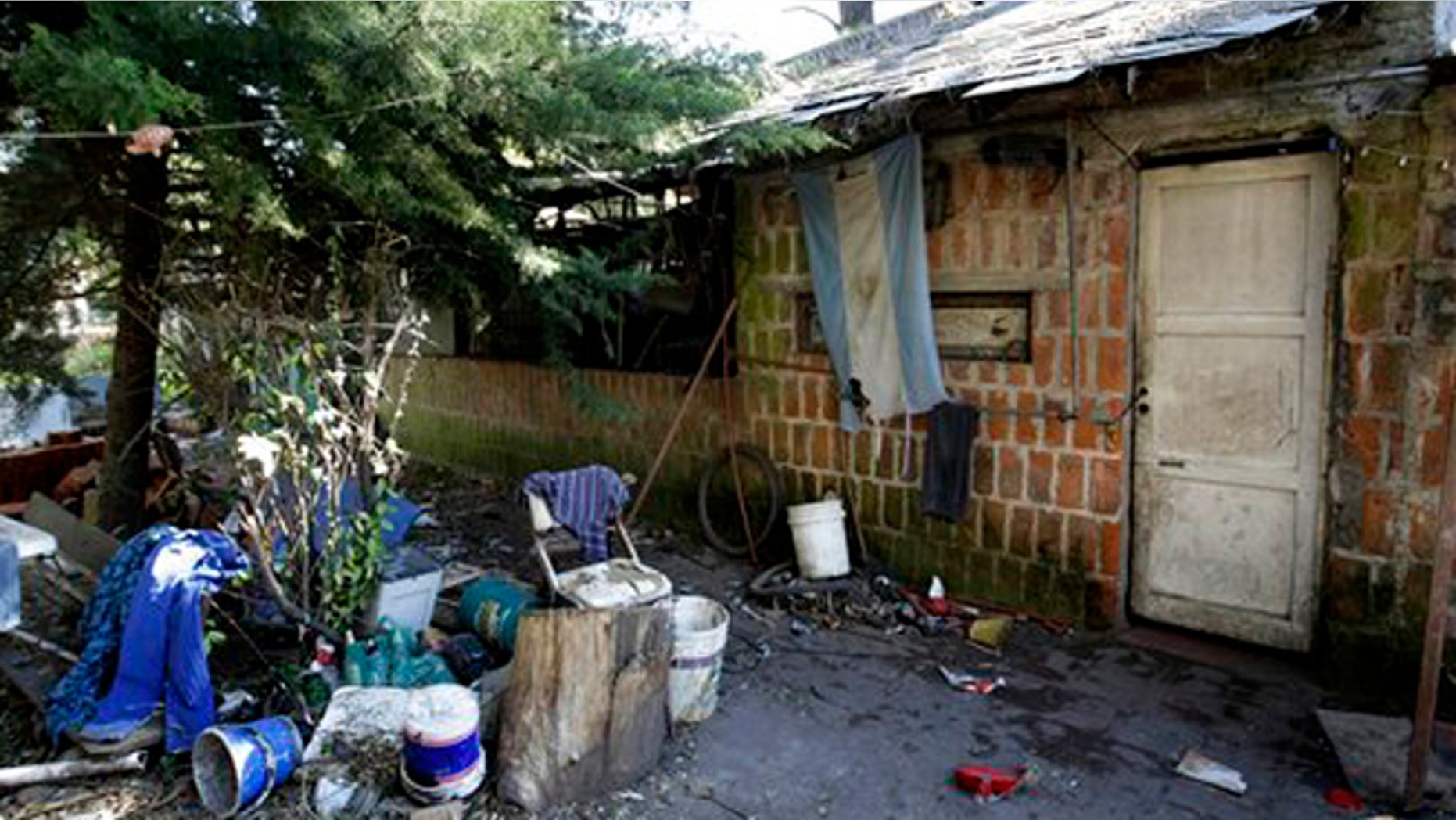 Sept. 5, 2015: An Argentine flag hangs from the home where Eduardo Oviedo is accused of keeping his wife and autistic son locked up in Mar del Plata, Argentina.