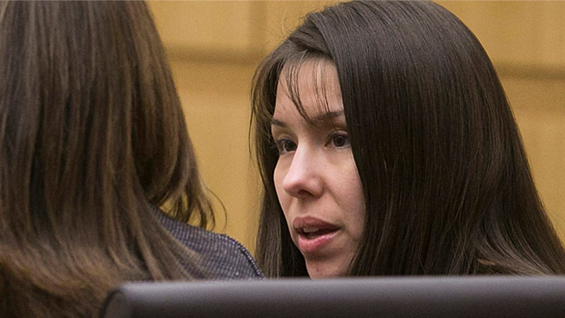 Jan. 2, 2013: Defendant, Jodi Arias, right, talks with her defense team during the prosecution's opening statements in the trial of Arias in Maricopa County court in Phoenix on Wednesday.