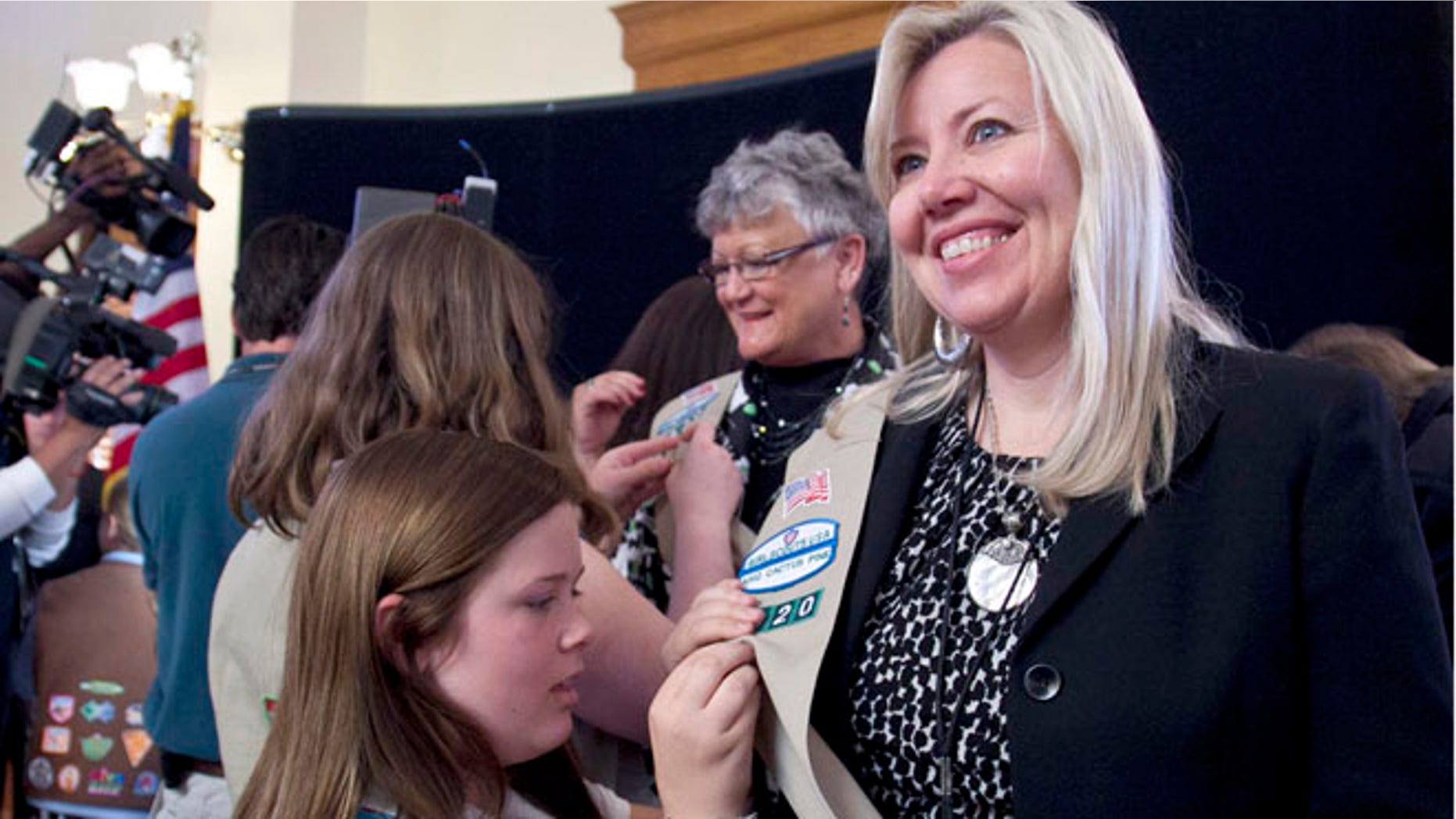 In this March 12, 2012, file photo, Arizona House Majority Whip Debbie Lesko is pinned by girl scouts during a ceremony in the old Senate Chambers in Phoenix. The Republican legislator is sponsoring a bill that could force women to prove to their employers that theyâre taking birth control for a medical reason such as acne, rather than to prevent pregnancy. (AP Photo/The Arizona Republic, Dave Seibert)