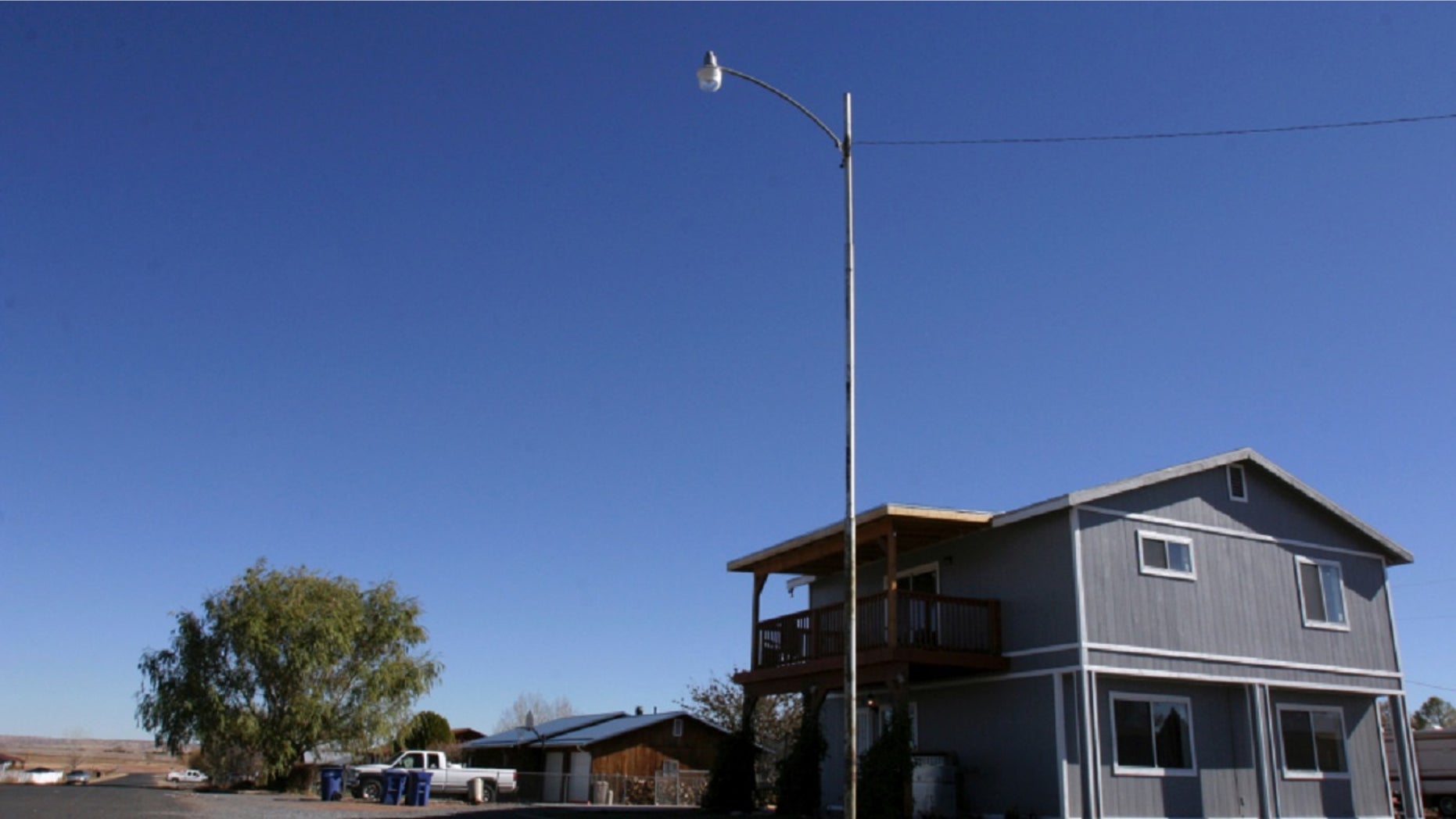 The house in St. Johns, Ariz. where Vincent Romero and Timothy Romans, of San Carlos, Ariz., were found fatally shot. Police said Romero’s 8-year-old son shot the men as they returned home from work. Romans rented a room in the two-story blue house that Romero shared with his new wife and son.