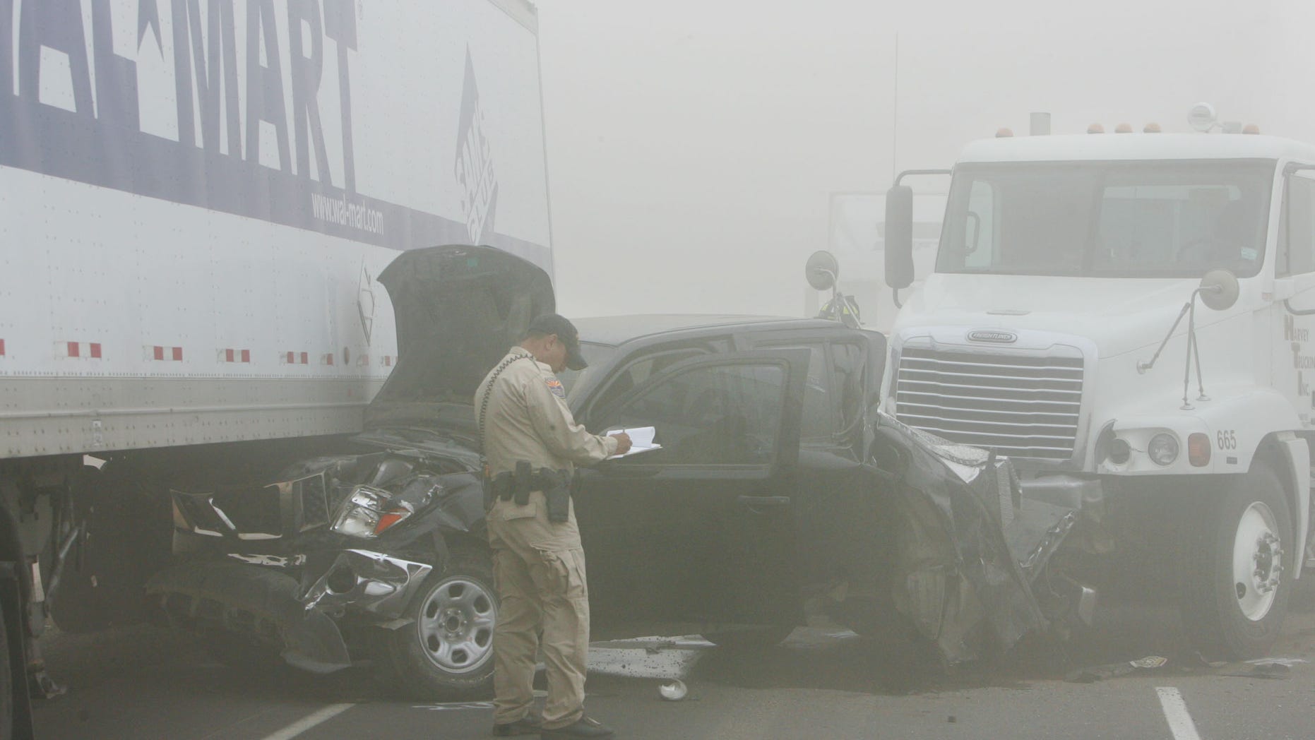 Oct. 4: An Arizona Departmaent of Public Safety Highway Patrol officer investigates the scene of a pileup caused by a dust storm on Interstate 10 west of Casa Grande, Ariz. A blinding dust storm rolled across the Arizona desert Tuesday, causing three pileups involving dozens of vehicles on the major interstate. One man was killed and at least 15 other people were injured, authorities said.