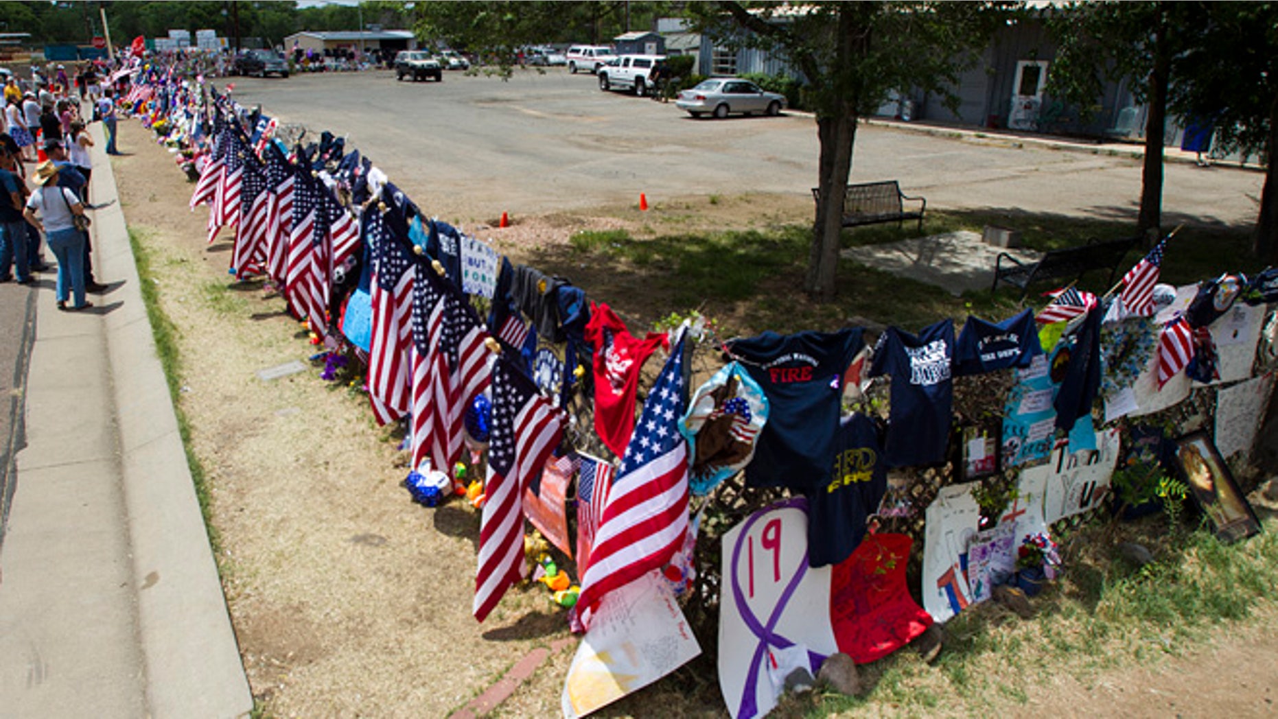 July 6, 2013: Items are displayed at a makeshift memorial at the Fire Station No. 7 memorial for fallen firefighters Saturday, July 6, 2013, in Prescott, Ariz. Nineteen Granite Mountain Hotshot firefighters were killed by an out-of-control blaze near Yarnell, Ariz. on June 30.
