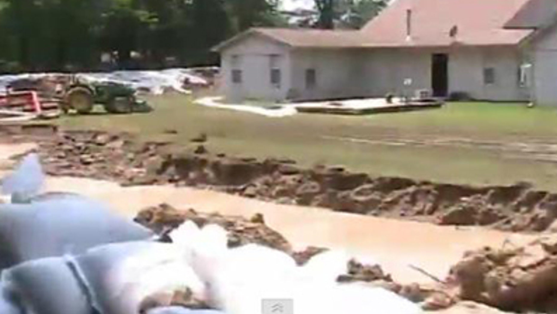 Russell Petty of Devalls Bluff, Ark., has built a moat and levee to protect his property from rising floodwaters.