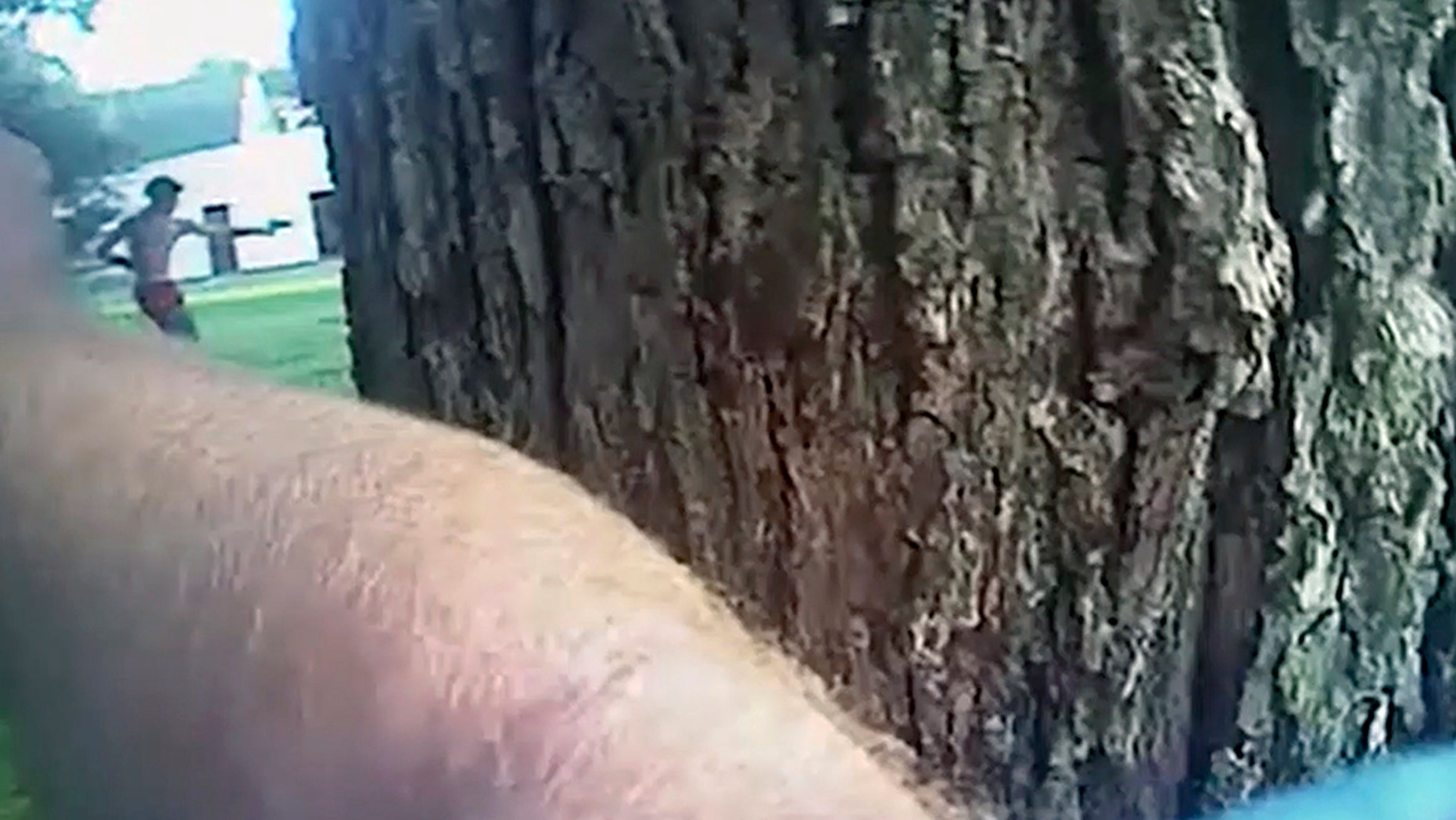 This image taken from police body camera video shows Aries Clark, 16, raising a black BB gun that looked like a handgun at officers before he was shot in Marion, Ark. July 25.