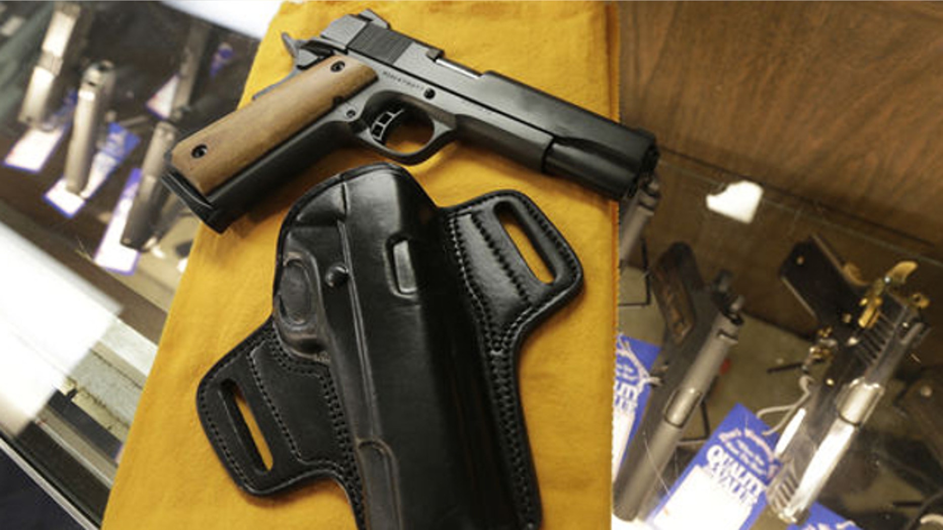 Aug. 24, 2013: A semi-automatic handgun and a holster are displayed at a North Little Rock, Ark., gun shop Thursday, Aug. 22, 2013. A march by by advocates of open carrying of guns is planed for Saturday in Fort Smith, Ark.