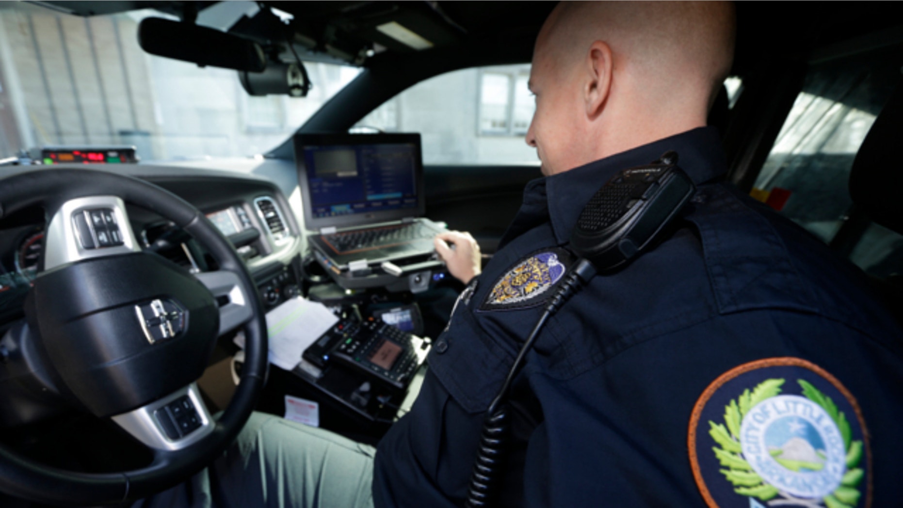 Jan. 16, 2013: Little Rock Police Officer Grant Humphries loos at a computer monitor connected to a camera mounted near the rear window of his patrol car in Little Rock, Ark.