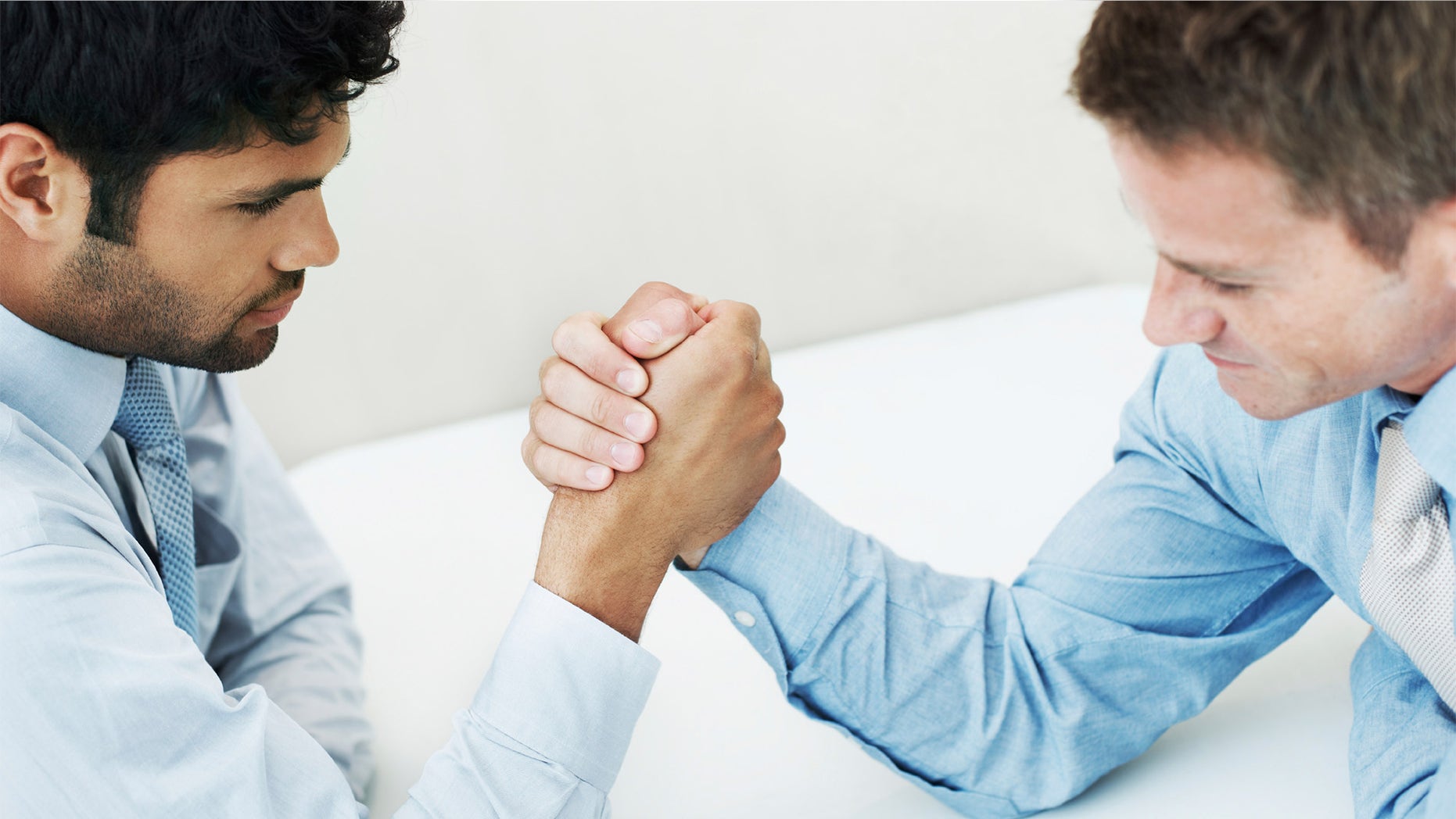 businessmen arm wrestling