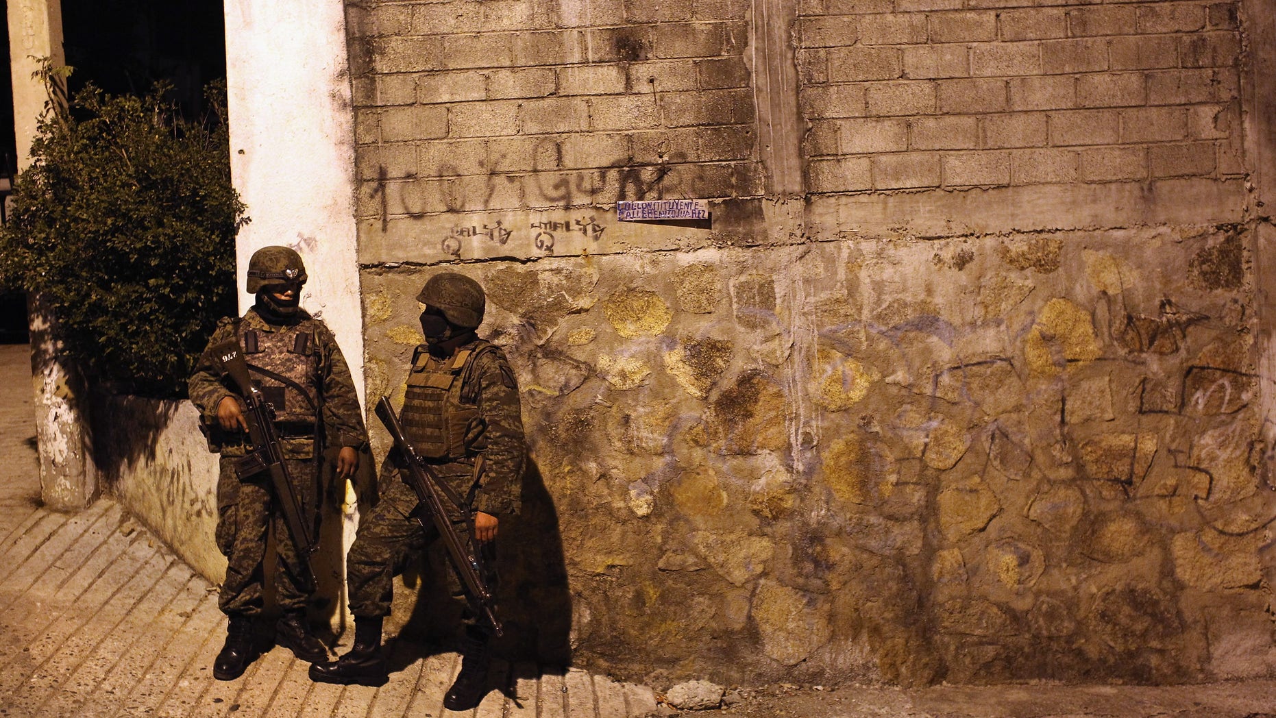 ACAPULCO, MEXICO - MARCH 03: Mexican army soldiers stand guard near a suspected drug-related murder site March 3, 2012 in Acapulco, Mexico. A forensics team excavated five corpses from the floor of an abandoned house. Officials said the five victims were apparently buried alive in concrete. Drug violence has surged in the coastal resort in the last year, making Acapulco the second most deadly city in Mexico after Juarez. One of Mexico's top tourist destinations, Acapulco has suffered a drop in business, especially from foreign tourists, due to the violence. Toursim accounts for about 70 percent of the economy of Acapulco's state of Guerrero and 9 percent of Mexico's economy. (Photo by John Moore/Getty Images)