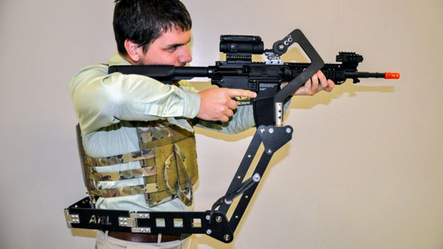 The Army Research Laboratory is developing a "third arm" passive mechanical appendage that could lessen Soldier burden and increase lethality. Weighing less than 4 pounds, the device attaches to a Soldier's protective vest and holds their weapon, putting less weight on their arms and freeing up their hands to do other tasks. (Photo Credit: U.S. Army)