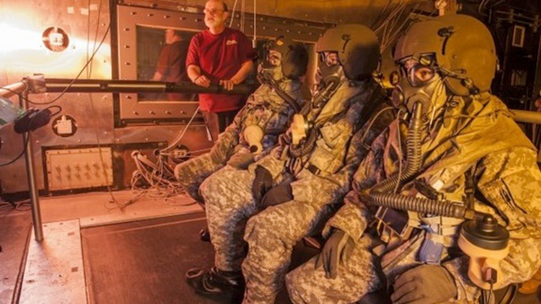 Bruce Cadarette, of the U.S. Army Research Institute of Environmental Medicine at Natick Soldier Systems Center in Natick, Massachusetts, monitors testing of a new personal cooling system for helicopter aircrews.