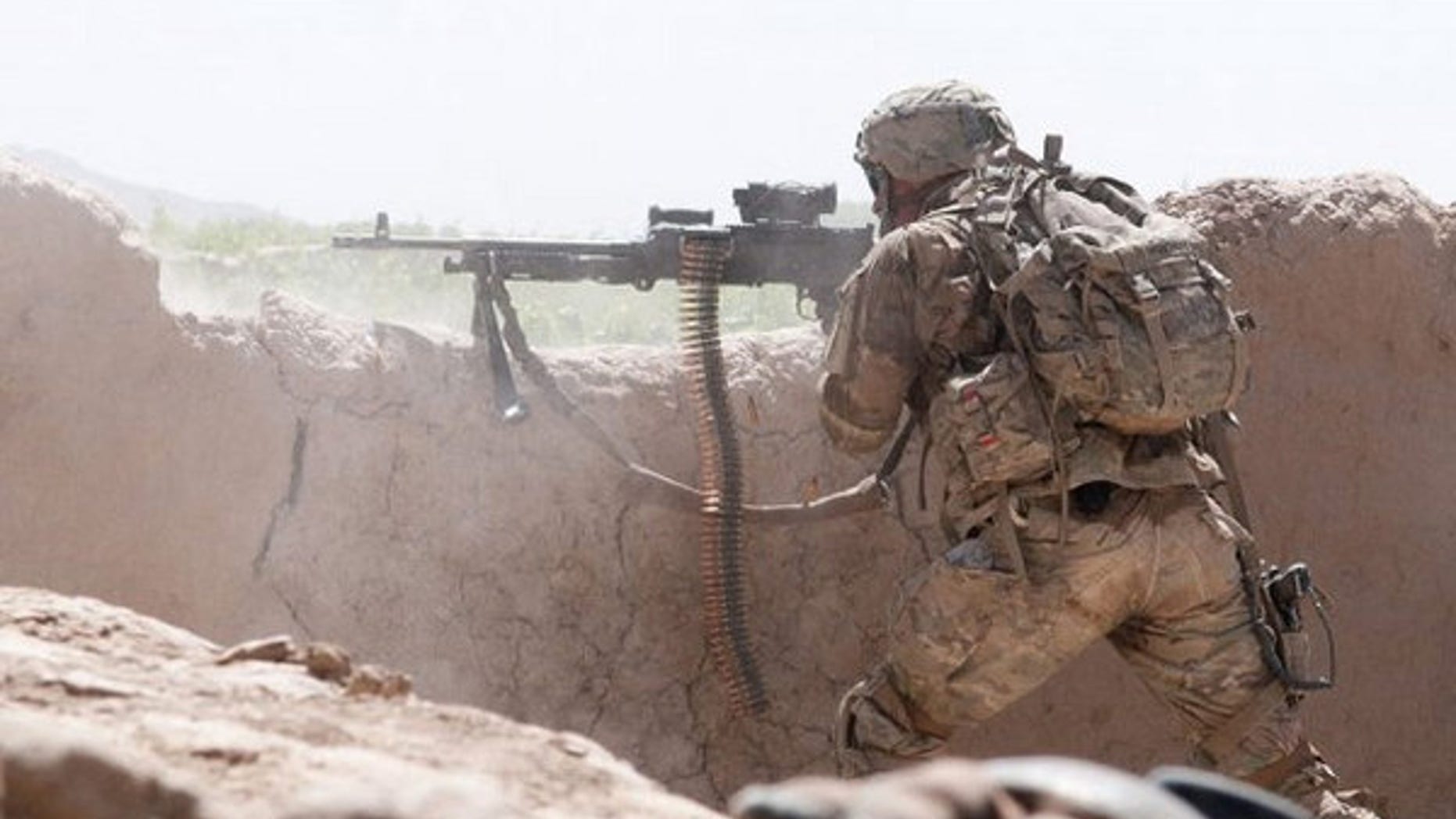A paratrooper with the 82nd Airborne Division's 1st Brigade Combat Team fires an M240B medium machine gun at insurgent forces in southern Ghazni Province, Afghanistan on June 15, 2012.
