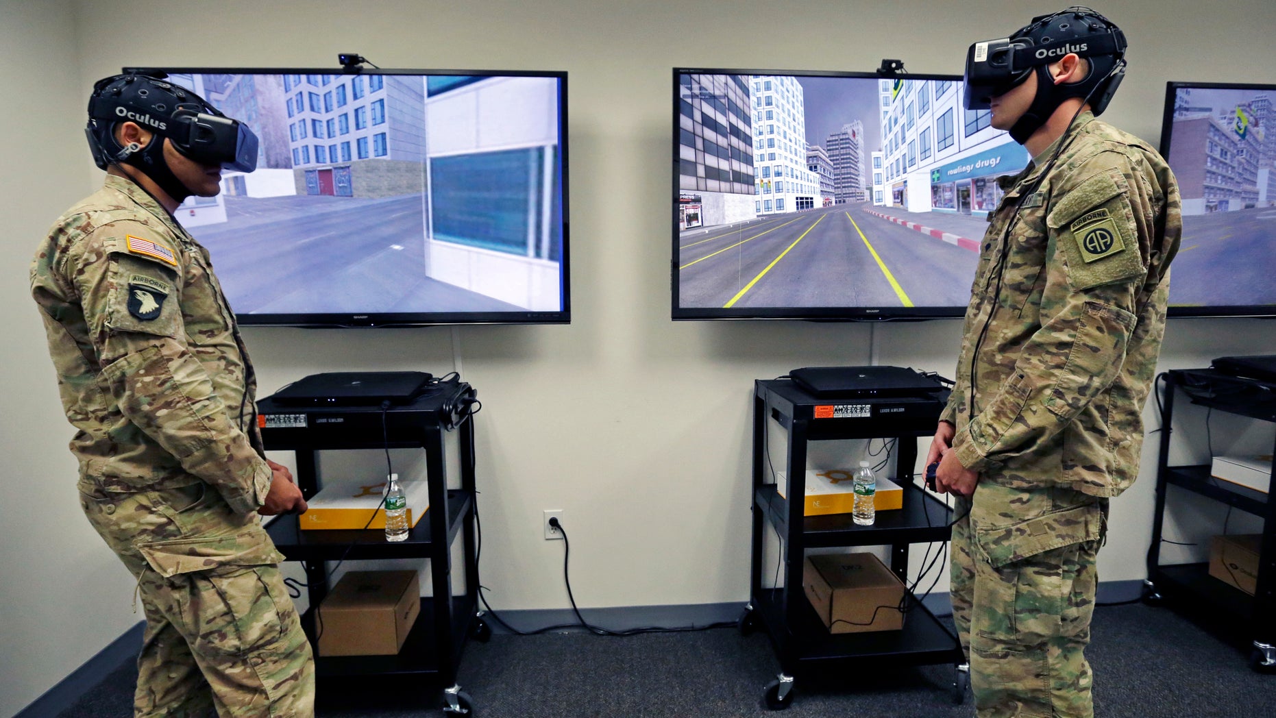 Soldiers wear virtual reality headsets as their neurological, psychological and behavioral responses are monitored during a team drill, Tuesday, Oct. 18, 2016, at the Center for Applied Brain and Cognitive Sciences in Medford, Mass. The Center was jointly founded by the Army's Natick Soldier Research, Development and Engineering Center and Tufts University's School of Engineering. (AP Photo/Elise Amendola)