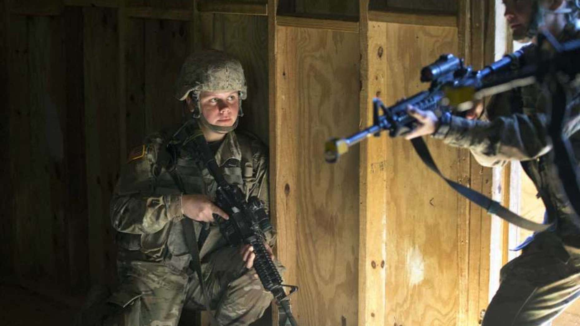 U.S. Army recruit Kirsten practices building clearing tactics with male recruits at Ft. Benning, Ga. She is one of a handful of women training to become infantry soldiers. As home to the previously all-male infantry and armor schools, Fort Benning had to make a number of adjustments, including female dorm rooms, security cameras, and monitoring stations. (AP Photo/John Bazemore)