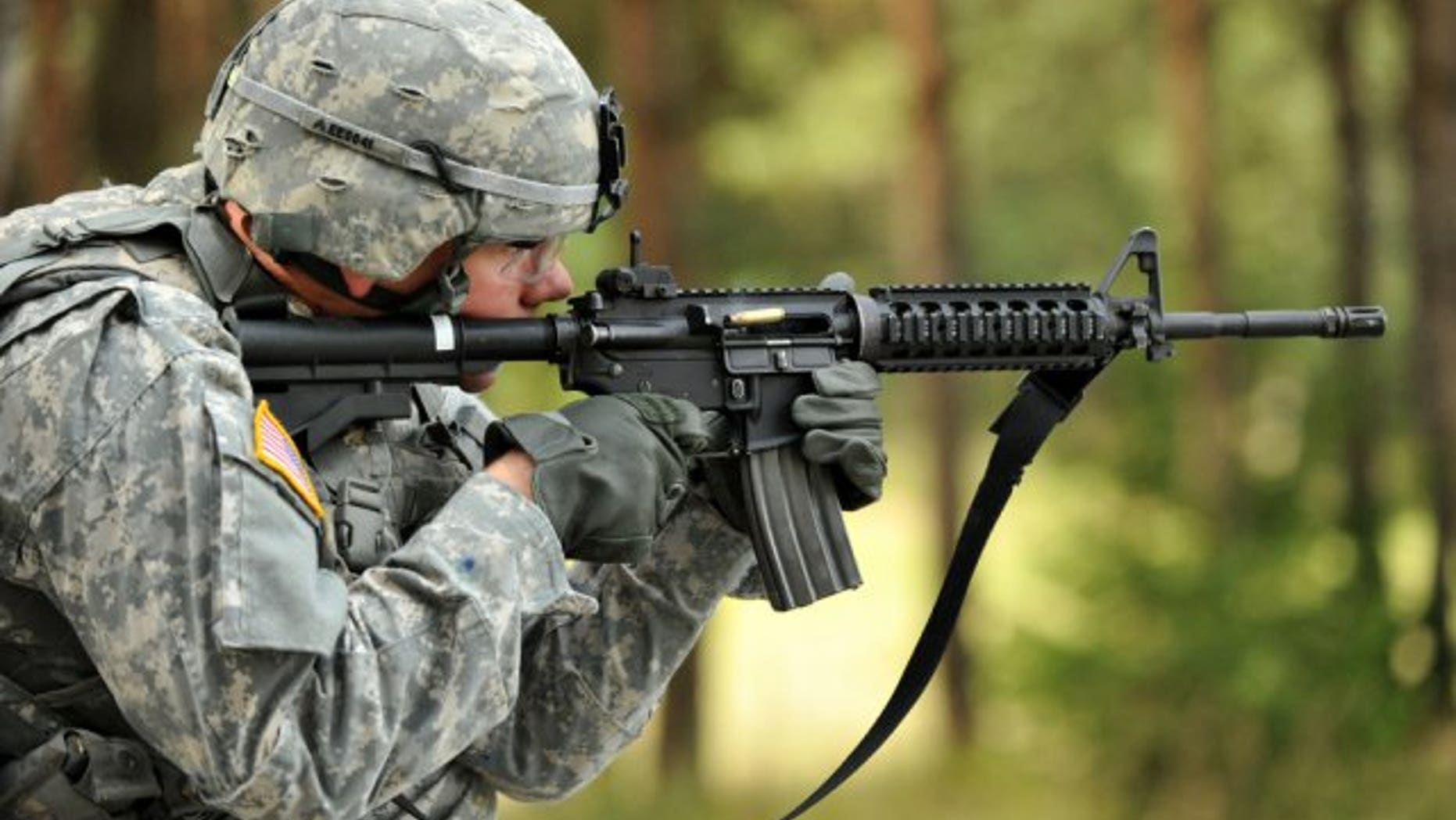Spc. Ethan Esposito, Joint Multinational Training Command, fires his M4 carbine rifle during United States Army Europe's Best Warrior Competition in Grafenwoehr, Germany, July 31, 2012. (U.S. Army)