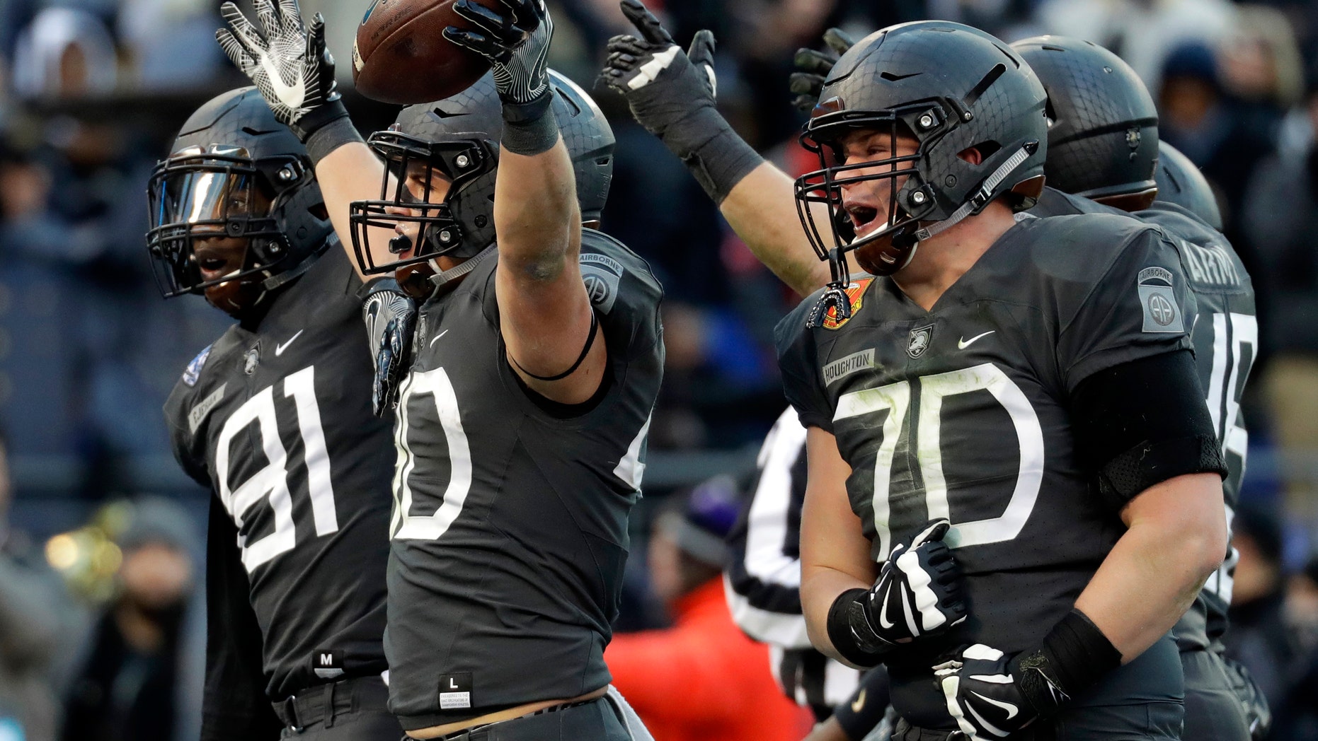 Army running back Andy Davidson (40) celebrates his touchdown with teammates in the first half of the Army-Navy NCAA college football game in Baltimore, Saturday, Dec. 10, 2016. (AP Photo/Patrick Semansky)