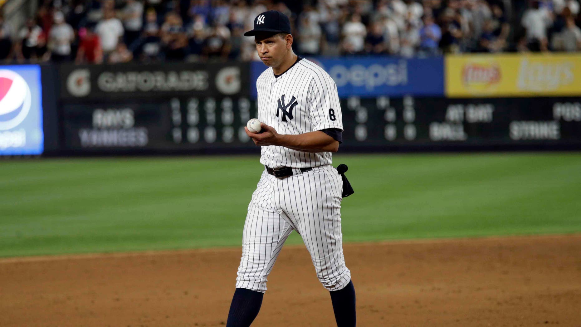 Alex Rodriguez walks towards third base in his final game as a Yankee player, Friday, Aug. 12, 2016, in New York.