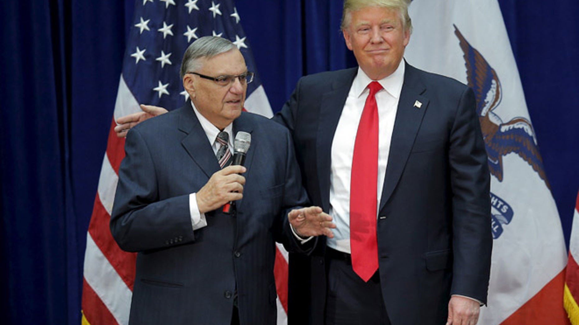In this Jan. 26, 2016 photo, Donald Trump is joined onstage by then-Maricopa County Sheriff Joe Arpaio at a campaign rally in Marshalltown, Iowa.
