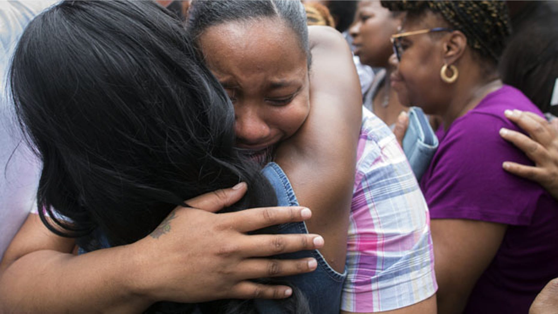 July 19, 2014: Emerald Garner, daughter of Eric Garner, mourns at the site of her father's death on a march following a service held in his name at the Mount Sinai Center for Community Enrichmen in the Staten Island borough of New York. (AP)