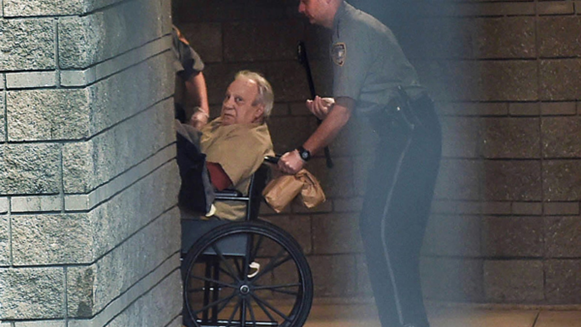 Robert Gentile is brought into the federal courthouse in a wheelchair for a hearing in Hartford, Conn.