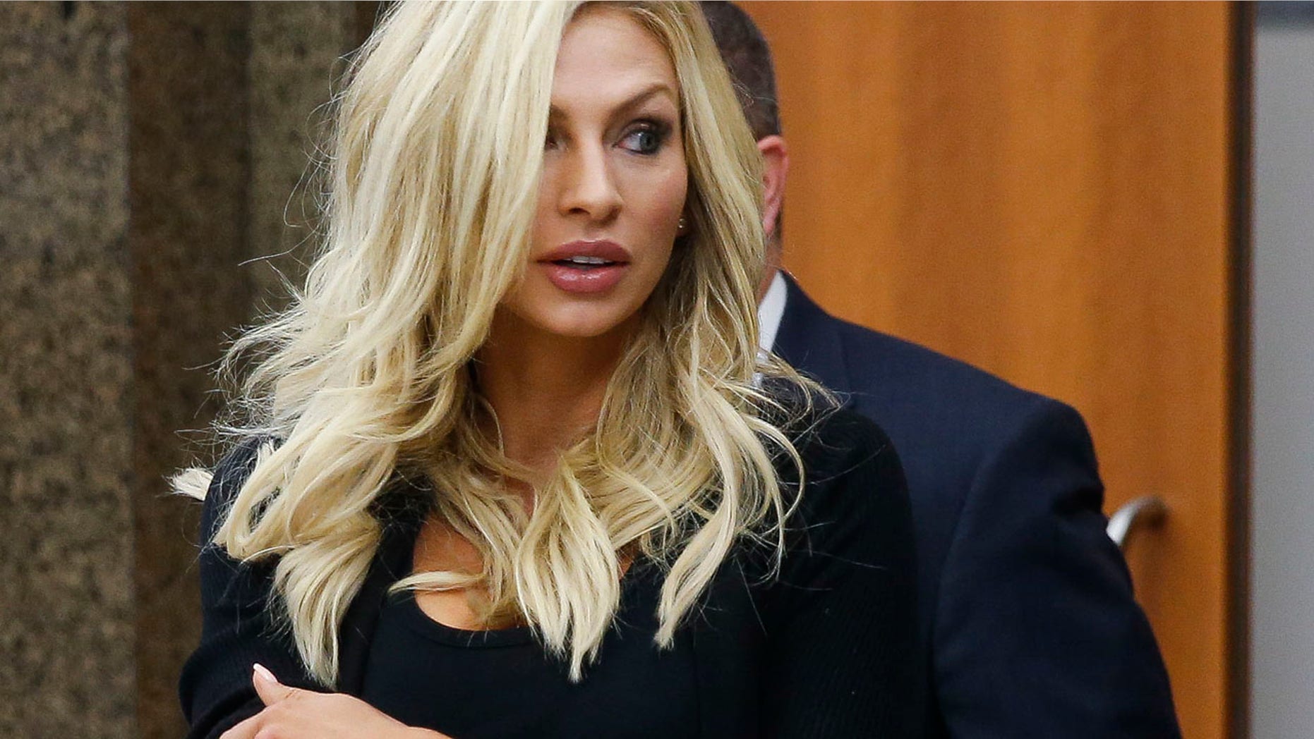Lindy Lou Layman walks out of court in Houston on Tuesday. She is challenging allegations that she caused at least $300,000 in damage to a prominent Houston attorney's art collection