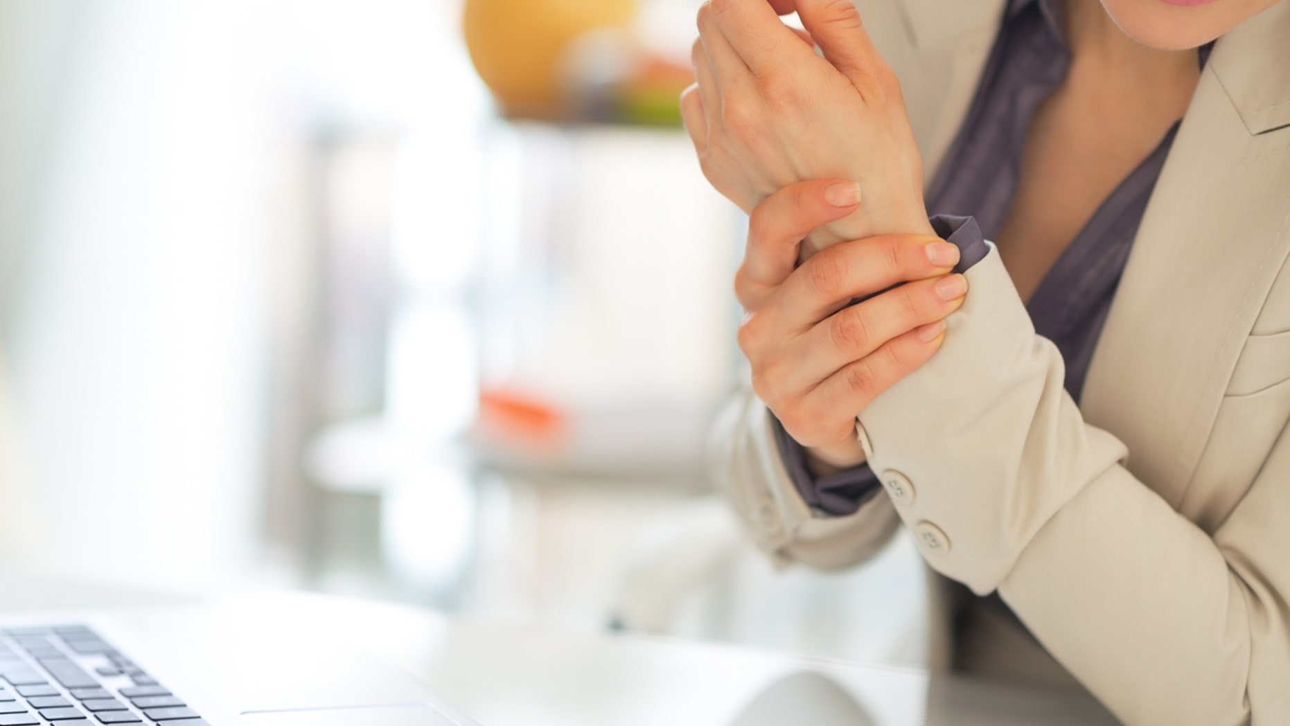 Closeup on business woman with wrist pain