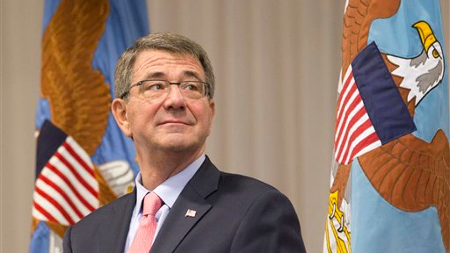 Defense Secretary Ash Carter watches during a change of command ceremony, Thursday, Jan. 14, 2016, at U.S. Southern Command in Miami. Ten prisoners from Yemen who were held at Guantanamo Bay, Cuba have been released and sent to the Middle Eastern nation of Oman for resettlement, Carter said Thursday. (AP Photo/Wilfredo Lee)