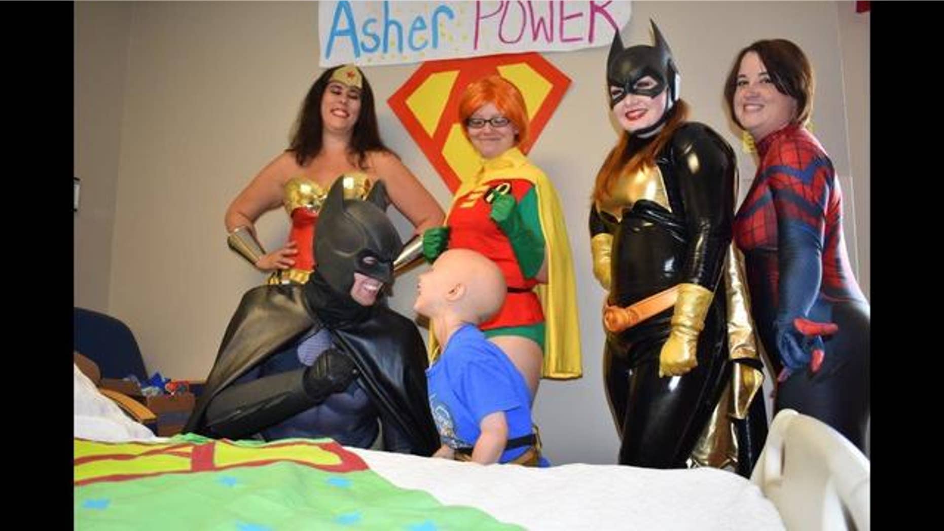 Asher Thrift smiled from ear-to-ear on when Batman, Robin, Batgirl, Wonder Woman, and Spiderman all came into his room.