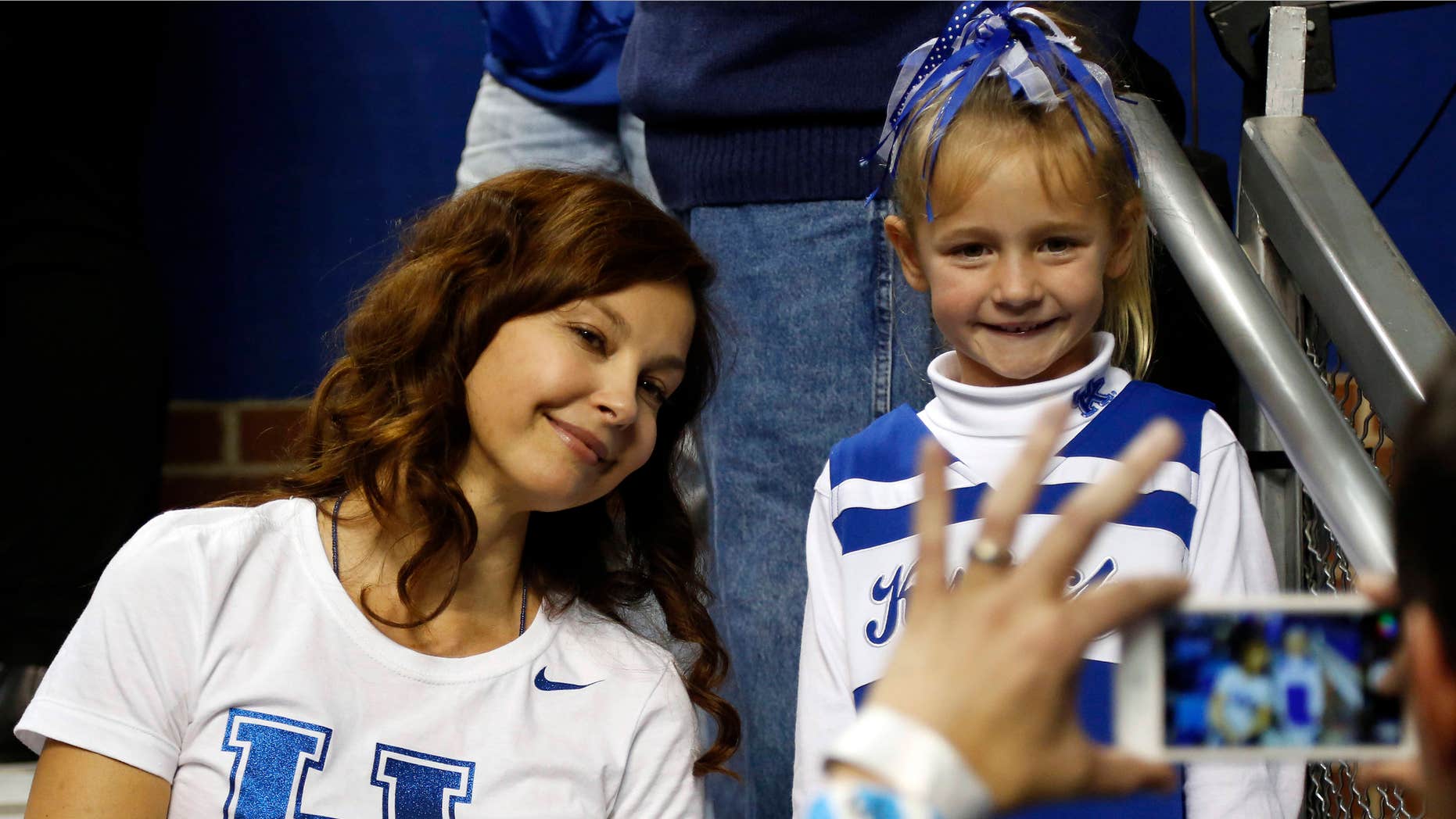 March 7, 2015: Actress Ashley Judd, left, poses with a young fan after an NCAA college basketball game between Florida and Kentucky.