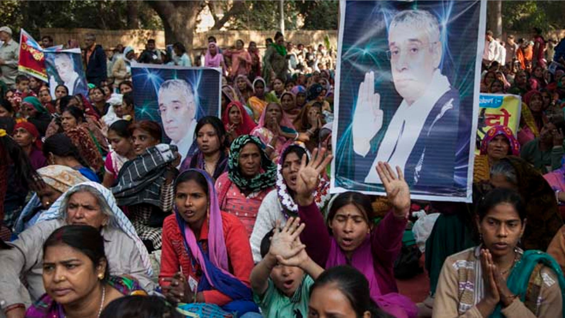 Nov. 18, 2014: Supporters of controversial Indian guru Sant Rampal displaying his photographs, chant slogans praising him as they gather to show support at a protest venue near the Indian Parliament in New Delhi, India. In the neighboring Haryana states Hisar district, several supporters were injured on Tuesday after police searching for Rampal stormed an ashram where he was believed to be holed up.