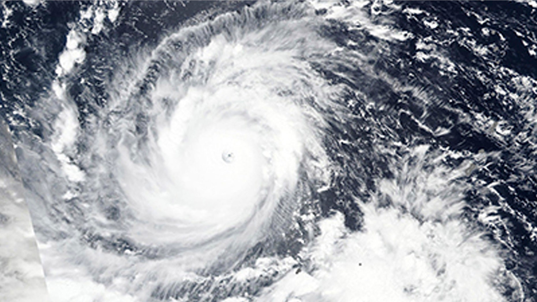n this Wednesday, Sept. 12, 2018, NASA satellite image, Super Typhoon Mangkhut churns west towards the Philippines.