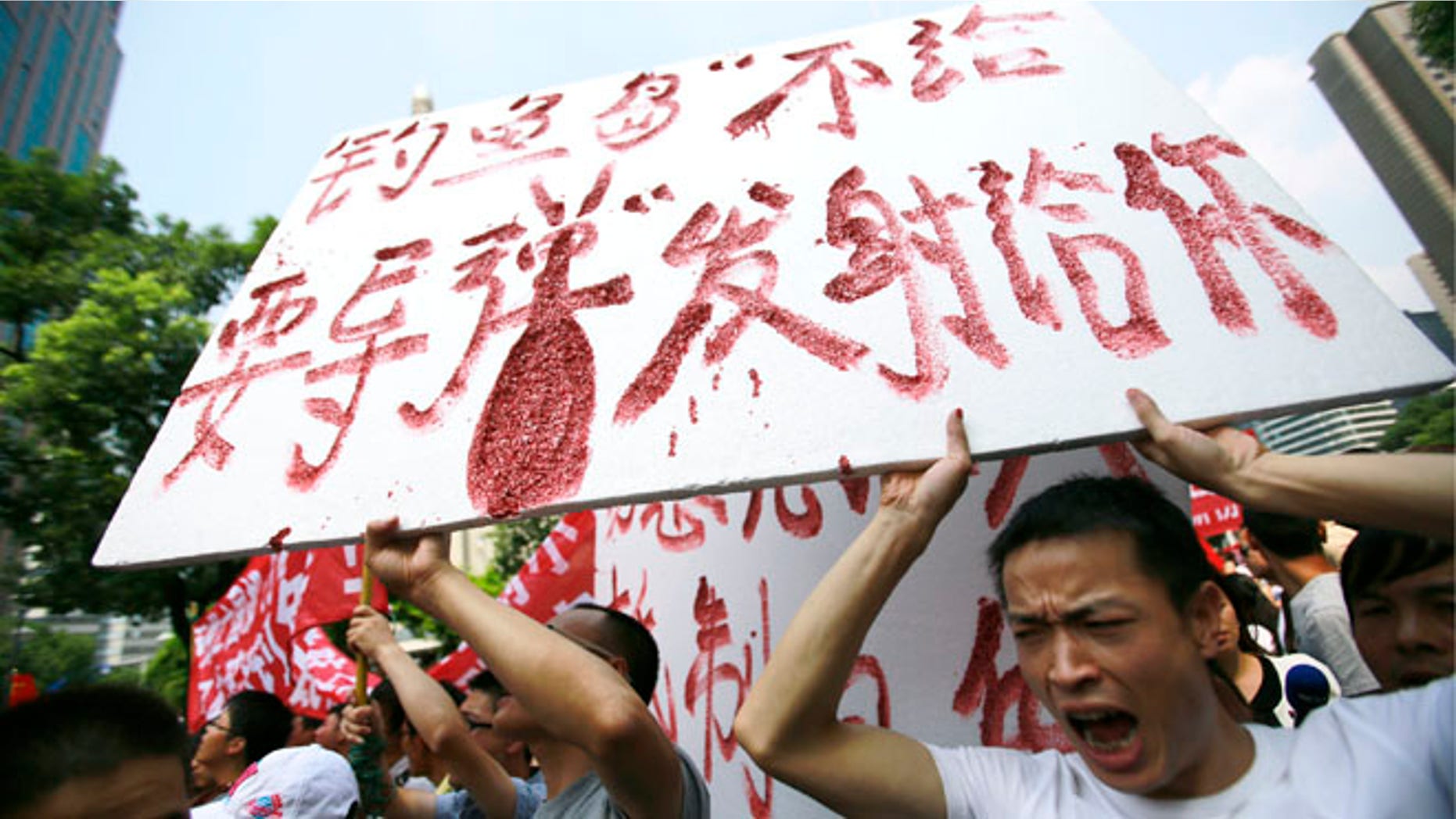 Sept. 18, 2012: Protesters shout anti-Japan slogans while holding a banner reading We wont give Diaoyu Island, but if you want the bomb, we want to give it to you near the Japanese Consulate General in Shanghai, China.