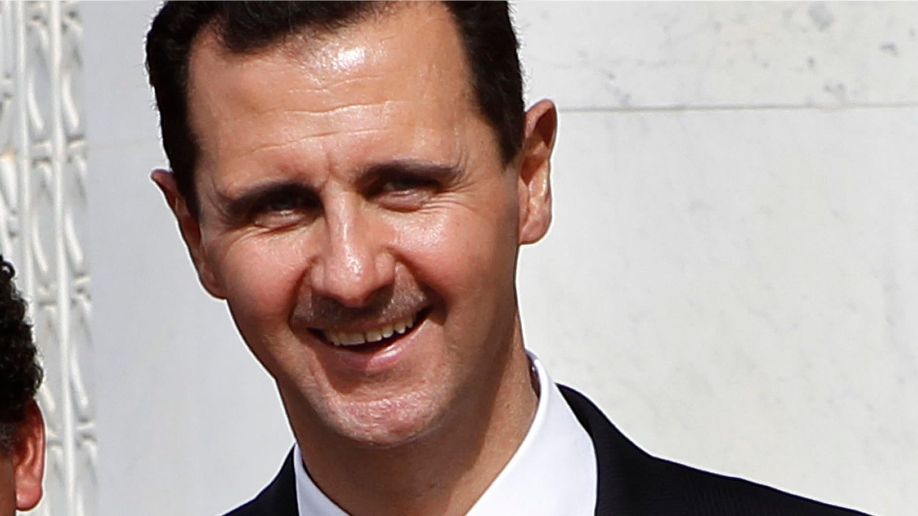 Oct. 21, 2010 : FILE - In this file photo, Syrian President Bashar Assad smiles as he shakes hands with Venesuela's President Hugo Chavez, not seen, at the Syrian presidential palace, in Damascus, Syria.
