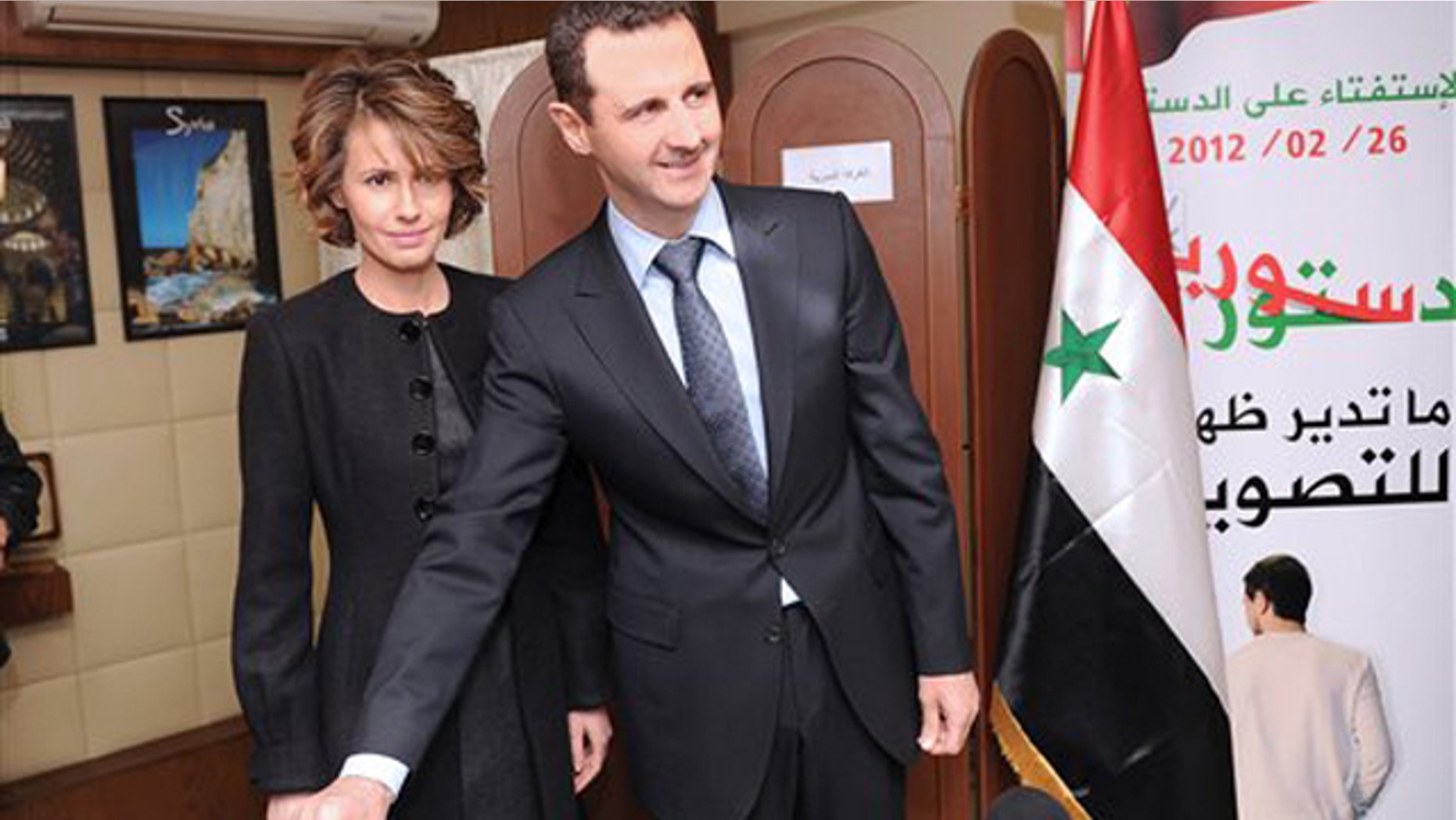 Feb. 26, 2012: In this photo released by the Syrian official news agency SANA, Syrian President Bashar Assad casts his ballot next to his wife Asma at a polling station in Damascus, Syria.