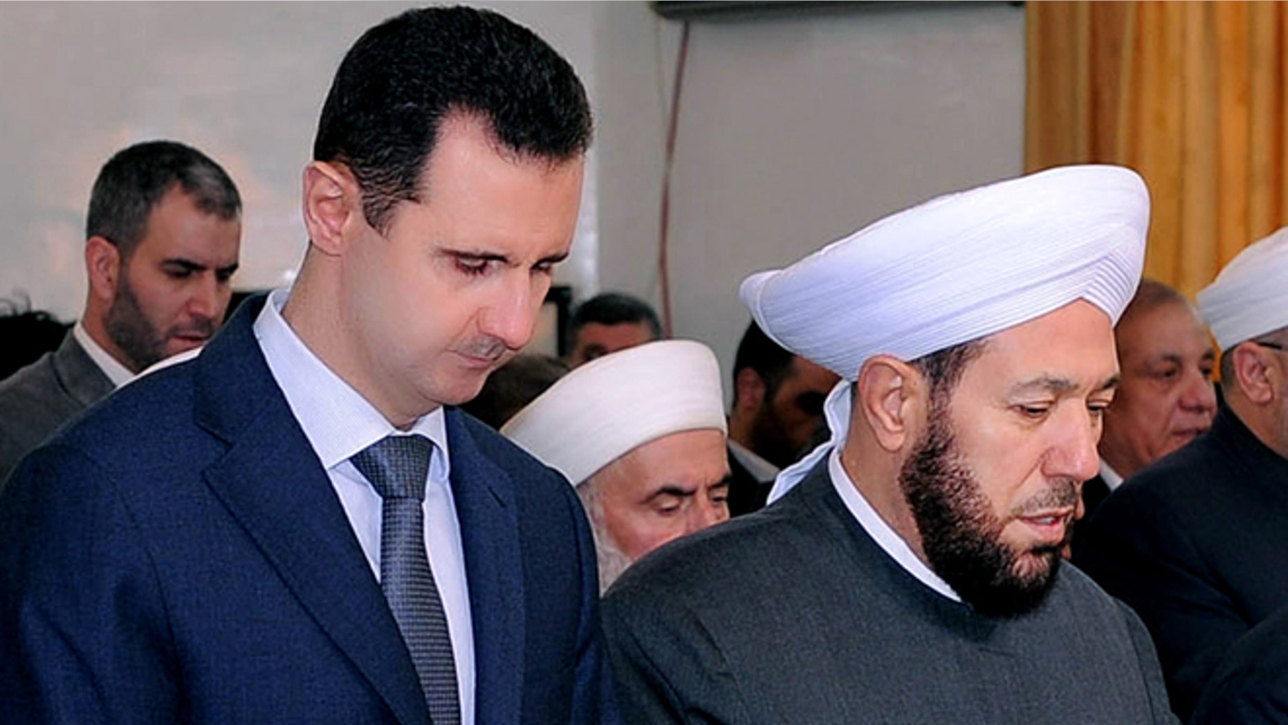Feb. 5, 2012: In this photo released by the Syrian official news agency SANA, Syrian President Bashar Assad, left, prays next to the Syrian grand mufti Ahmad Hassoun, right, during a ceremony marking the birth of Islam's Prophet Mohammad, at al-Rawda mosque, in Damascus, Syria. Hassoun's appeal for men to join the army raises the question of whether President Bashar Assad is running out of soldiers and prompts a pro-government newspaper to declare the military can battle insurgents for years to come.