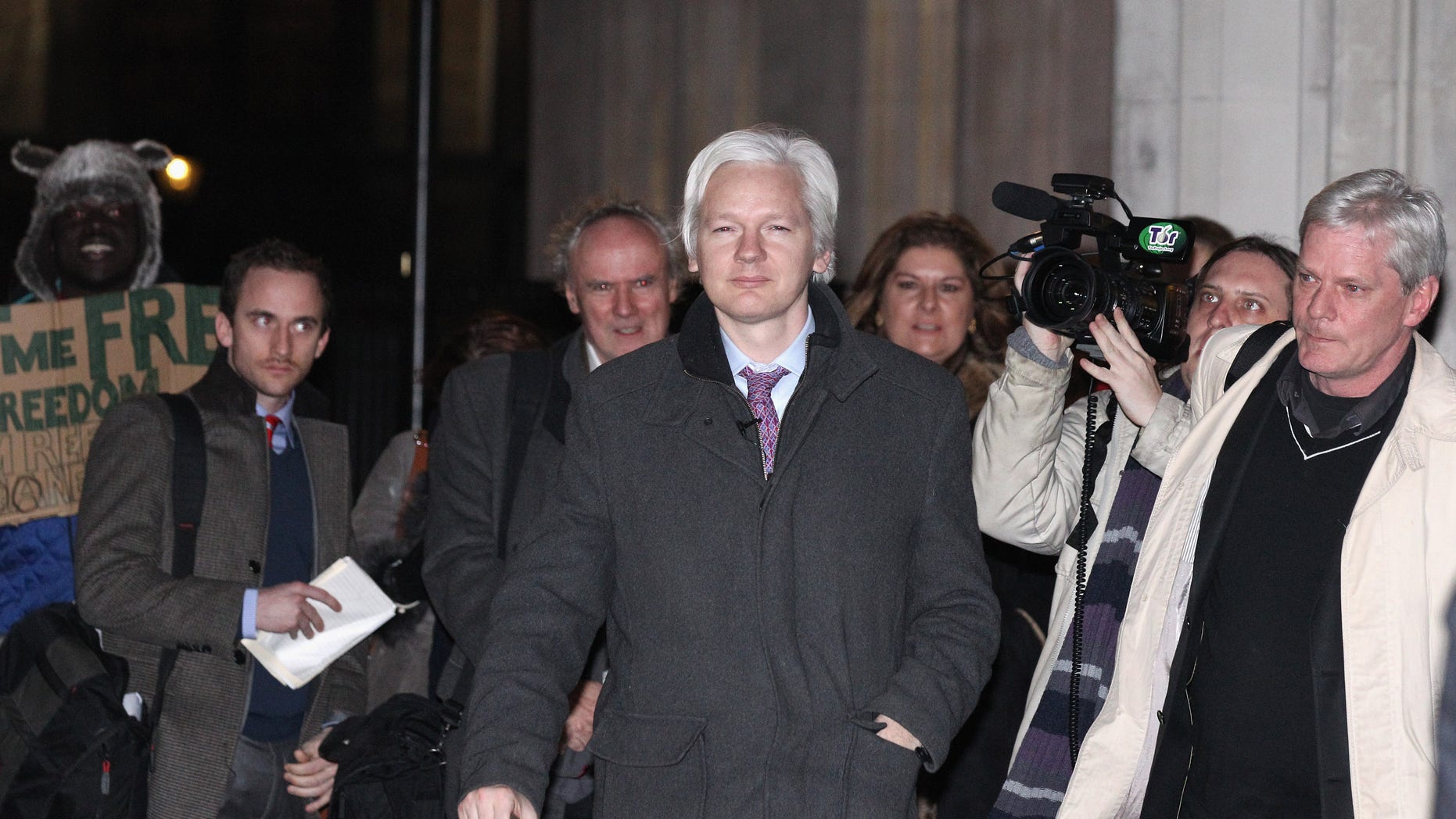 LONDON, ENGLAND - FEBRUARY 02: Julian Assange (C), the founder of the WikiLeaks whistle-blowing website, leaves the Supreme Court on February 02, 2012 in London, England. Mr Assange is appearing in court for his final UK appeal against his extradition to Sweden, where he is sought for questioning over alleged sex crimes. (Photo by Oli Scarff/Getty Images)