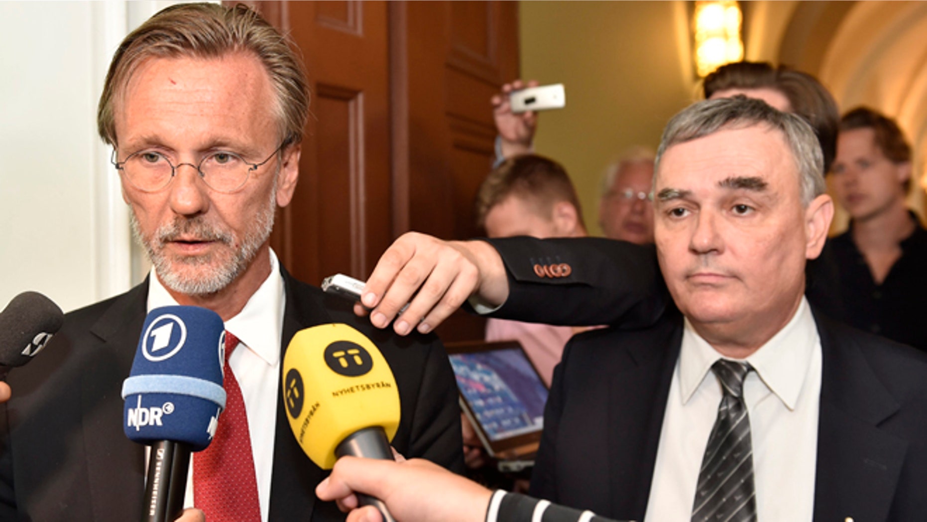 July 16, 2014: Julian Assange's lawyers Tomas Olsson, left, and Per E. Samuelsson talk to media prior to a public court hearing in Stockholm.