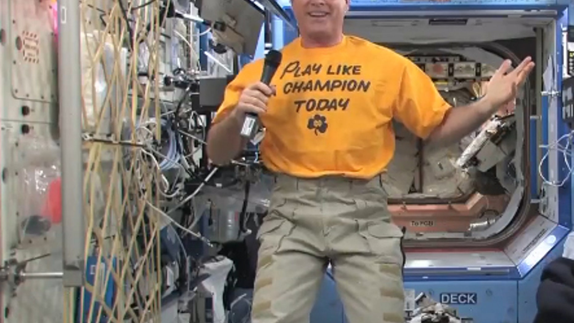 NASA astronaut Kevin Ford smiles while wearing his Notre Dame "Play Like a Champion Today" shirt on Dec. 26 to support the college's BCS Championship Game against Alabama on Jan. 7, 2013. Ford is the commander of Expedition 34 aboard the Intern