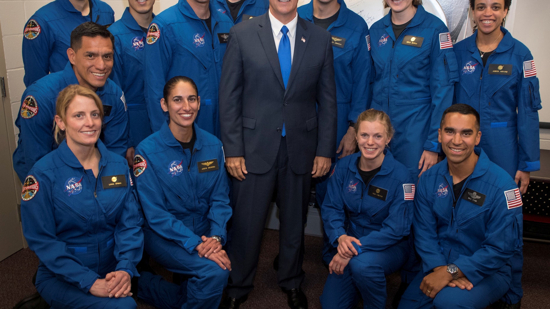 U.S. Vice President Mike Pence poses for a group photograph with NASA's 12 new astronaut candidates at NASAs Johnson Space Center in Houston, Texas, U.S., June 7, 2017. NASA astronaut candidates, standing from L-R, Robb Kulin, Jonathan Kim, Robert Hines, Warren Hoburg, Matthew Dominick, Kayla Barron, Jessica Watkins, from L-R kneeling, Francisco Rubio, Loral OHara, Jasmin Moghbeli, Zena Cardman, and Raja Chari. (Bill Ingalls/Courtesy NASA/Handout via REUTERS)
