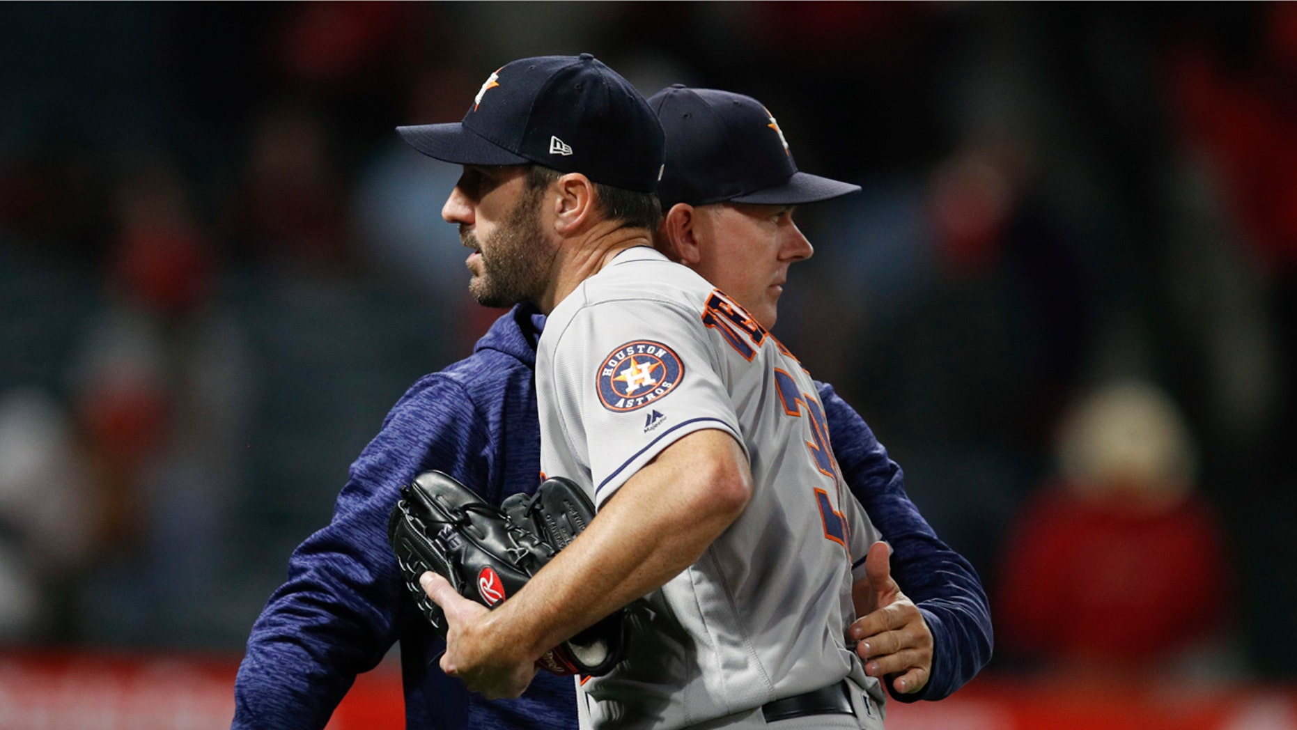 Houston Astros starting pitcher Justin Verlander gets a pack on the back from manager A.J. Hinch after the team's 2-0 win over the Los Angeles Angels in a baseball game Wednesday, May 16, 2018, in Anaheim, Calif.