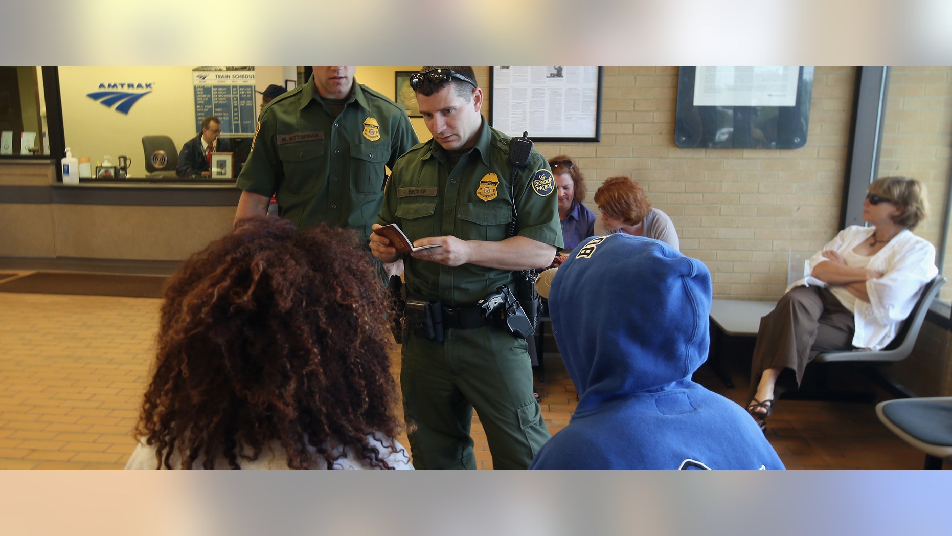 DEPEW, NY - JUNE 05: U.S. Border Patrol agents check passenger identifications at a train station on June 5, 2013 in Depew, New York. The agents set up a 24 hour check of transportation hubs in and around Buffalo. They said they received intelligence of undocumented immigrants passing through the area. The Border Patrol also monitors cross border traffic along the northern border between the United States and Canada. (Photo by John Moore/Getty Images)