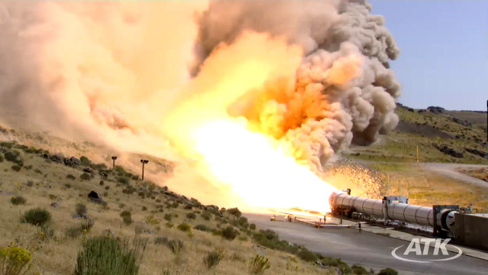 This still from an ATK webcast shows a side view of the five-segment solid rocket booster DM3 during a Sept. 8, 2011 static test firing at the company's motor proving grounds near Promontory, Utah.