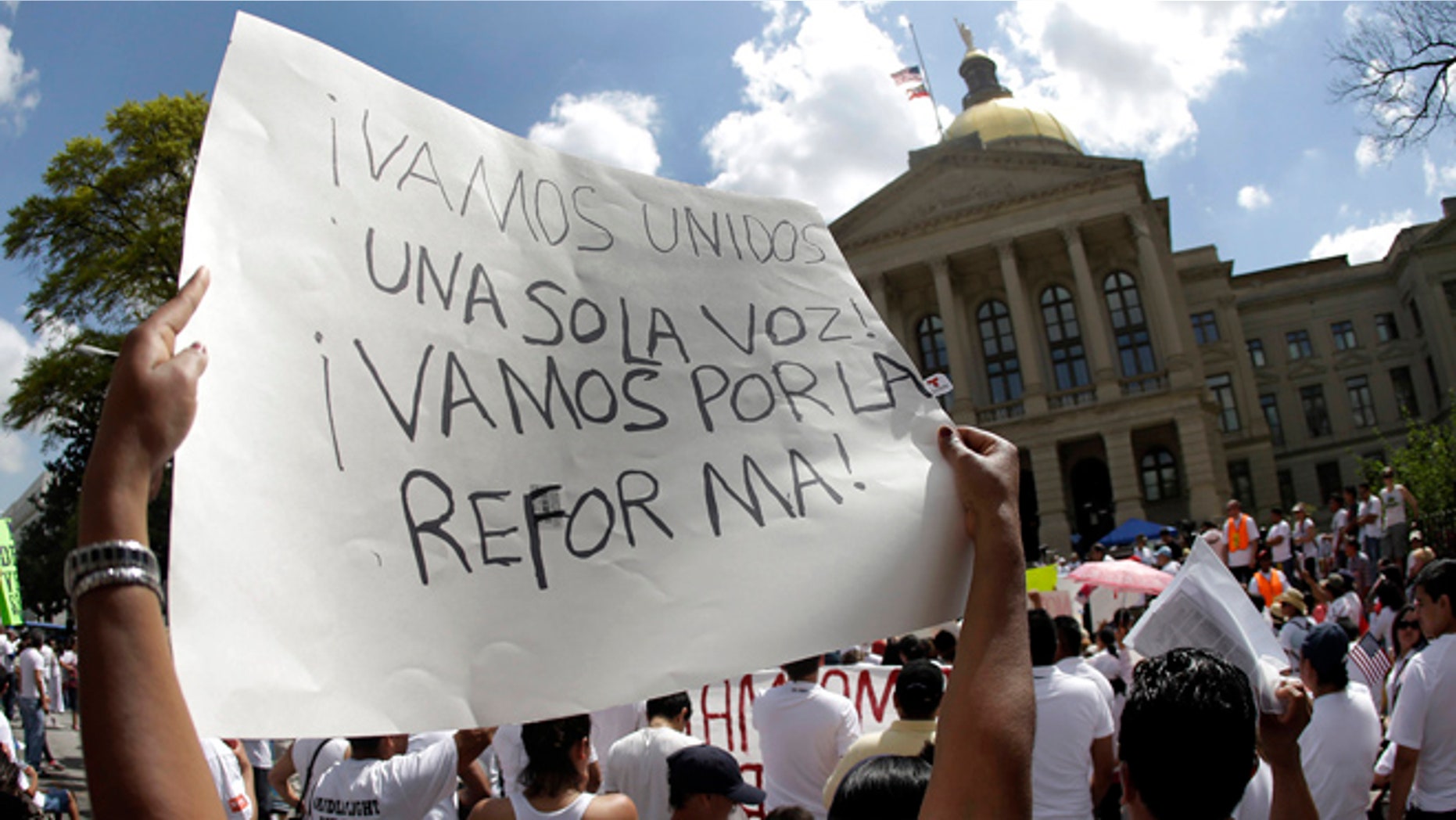 April 10, 2013: A protester for immigration reform holds a sign during a rally at the Georgia State Capitol in Atlanta.