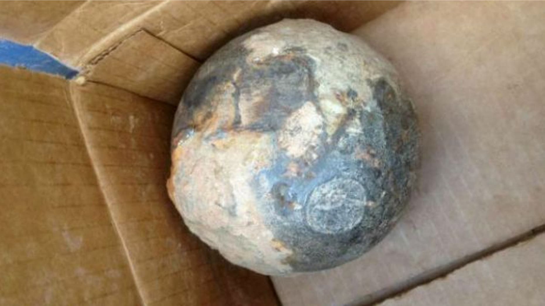 July 18, 2013: A photo provided by the Atlanta Police Department shows an object believed to be a cannonball that was unearthed during work at Centennial Olympic Park in downtown Atlanta.