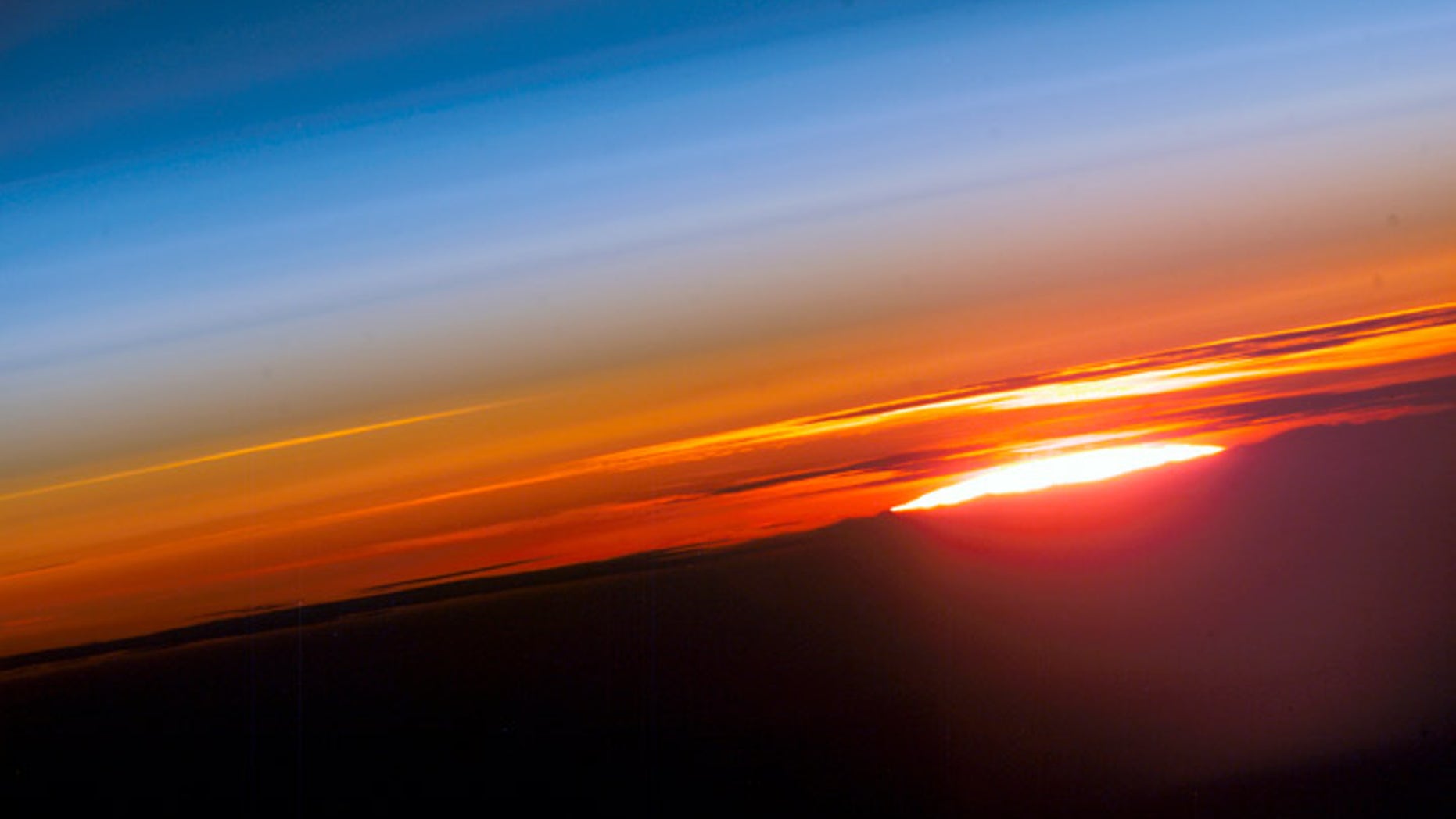 The sun rises over planet Earth in this photo an astronaut captured from the International Space Station.