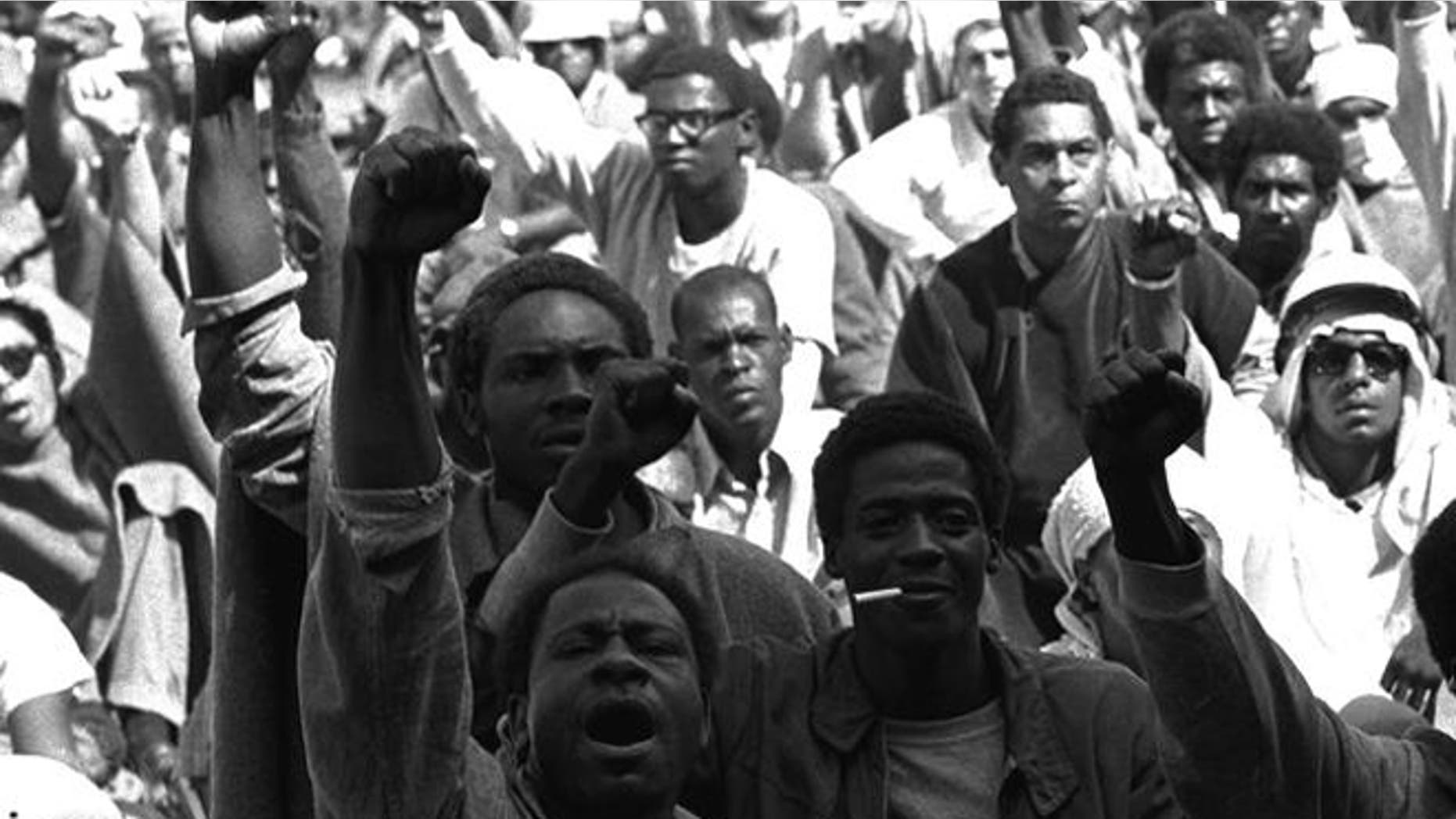 FILE 1971: Prisoners at Attica Correctional Facility raise clenched fists during riots.