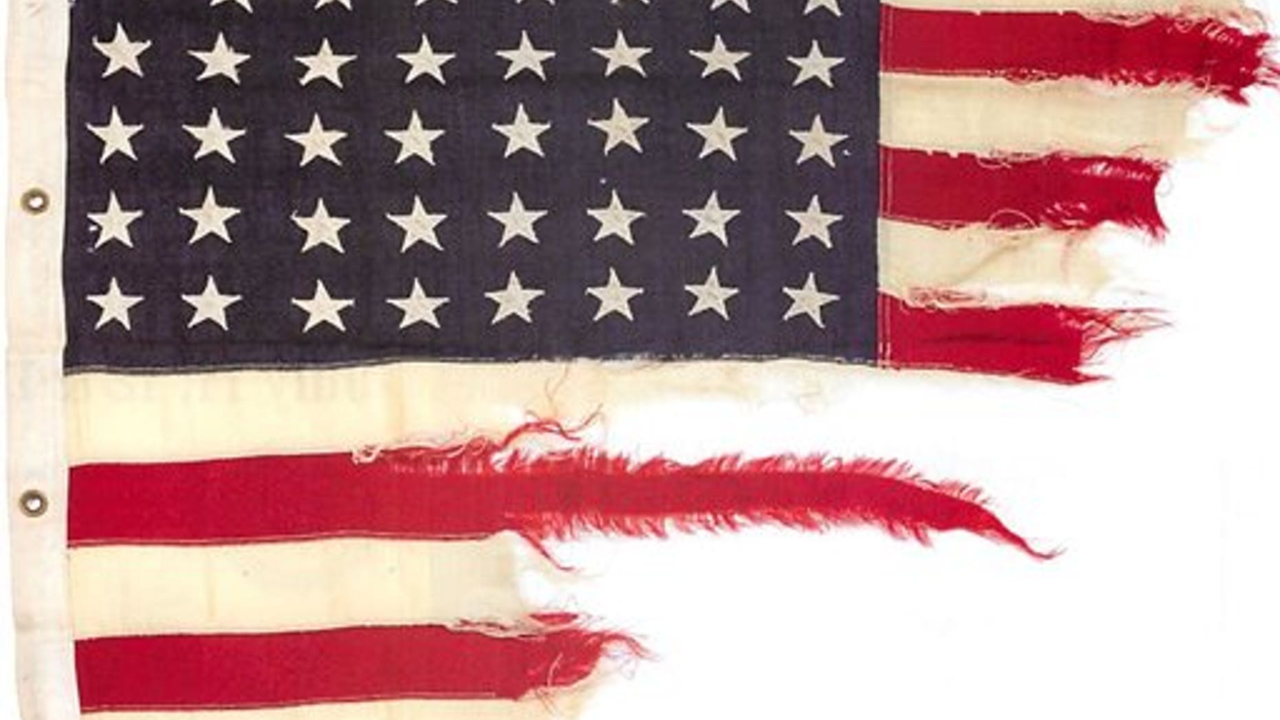This photo provided by Bonhams shows the tattered 48-star American flag that flew aboard the U.S.-built LST 493 on D-Day.