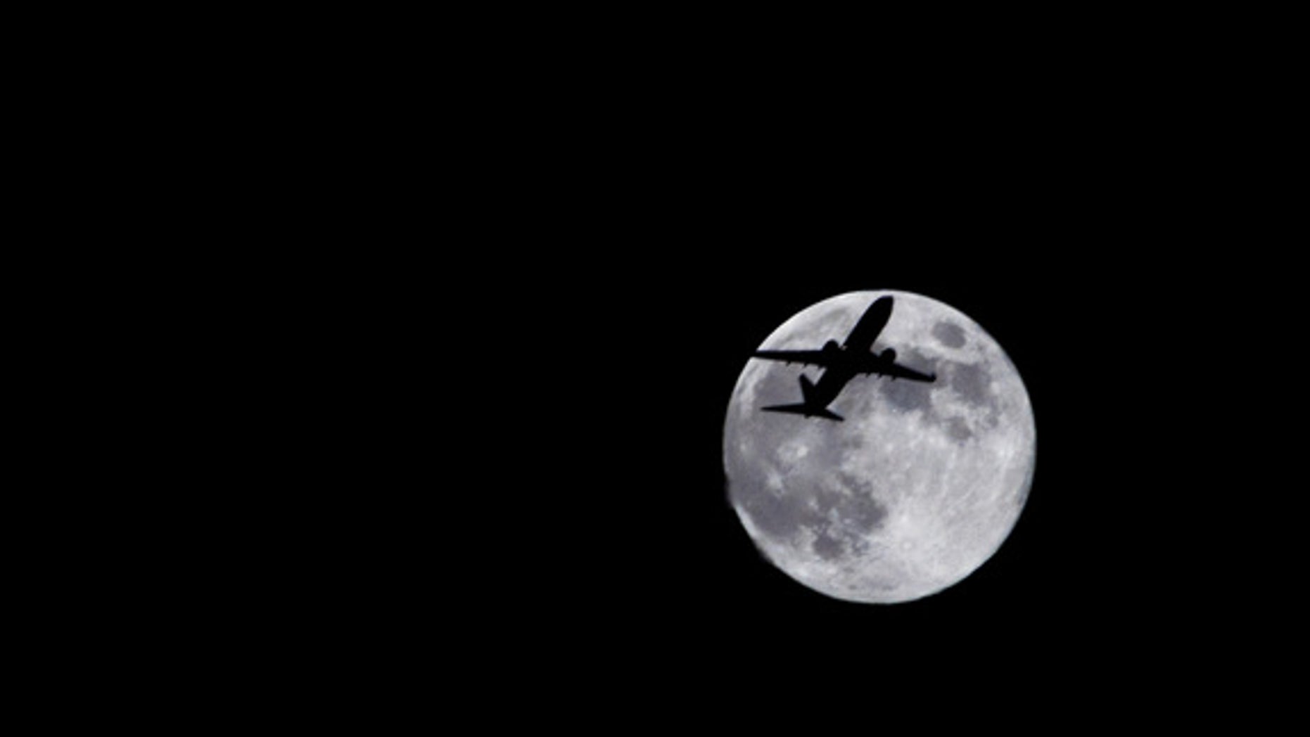Photographer Sid Vedula captured this amazing view of the full moon of Aug. 1, 2012, from Houston, TX, with a passing airplane in silhouette.