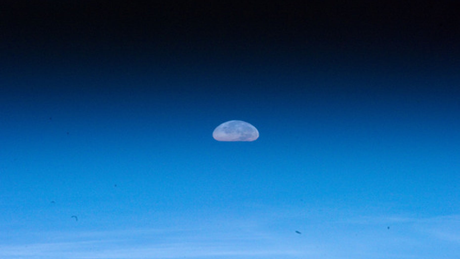 The Aug. 1, 2012, full moon appears squashed due to distortions by Earth's atmosphere in this photo by an astronaut on the International Space Station.