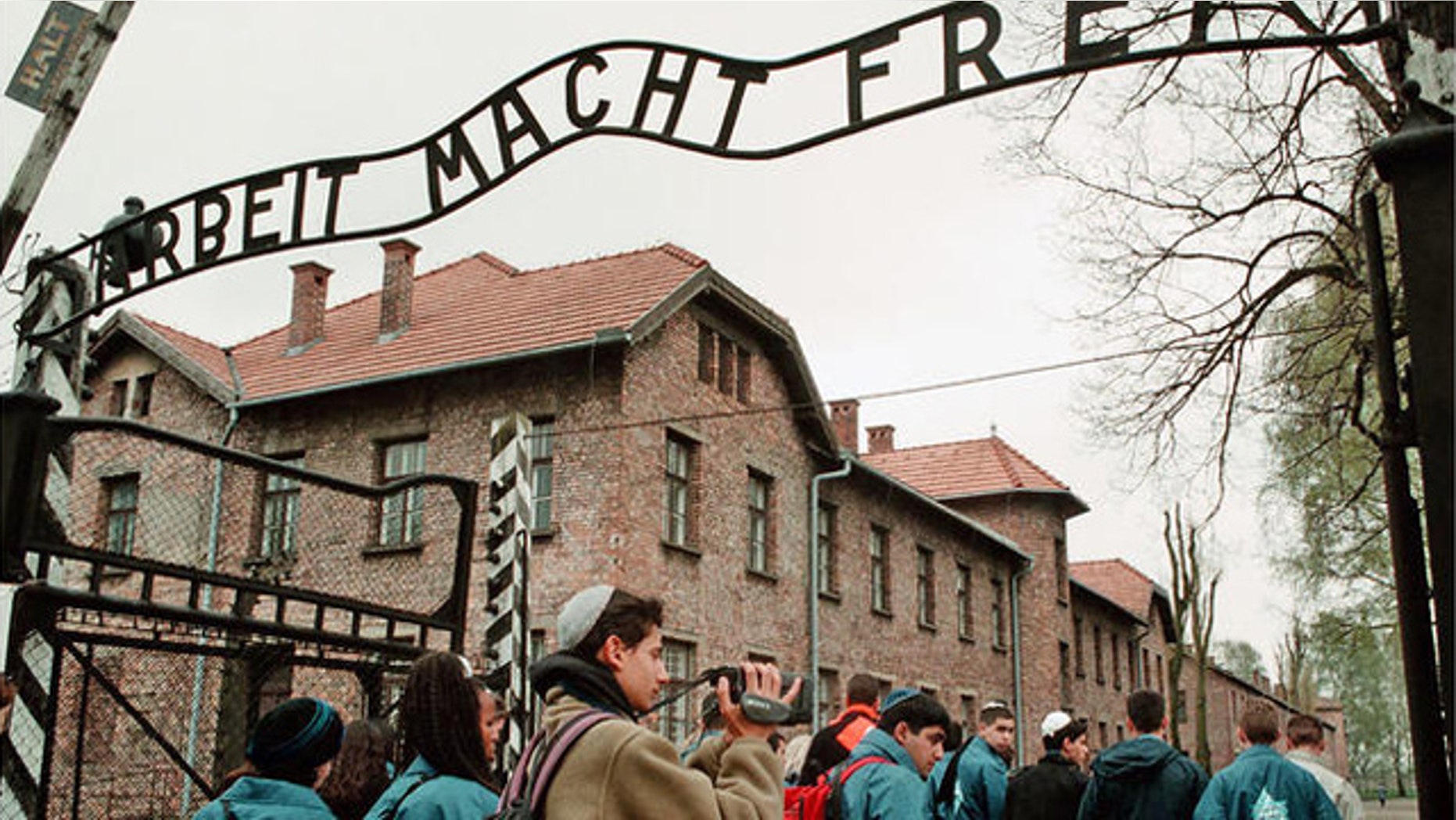 Young Israelis walk under the sign at Auschwitz concentration camp reading "Arbeit Macht Frei," (Work makes you Free).